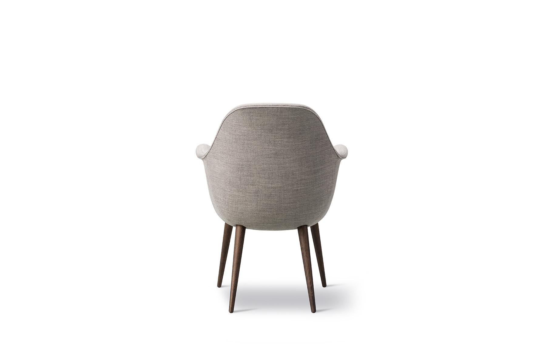 The Swoon chair is the smallest upright version of Swoon, is a size that’s even more compact. With its singular shell merging the armrests, seat and back, in addition to the supportive, soft cushions and choice of solid wood, you have a subtle,
