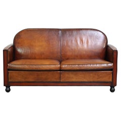 Spacious two-seater Art Deco design sofa made of sheepskin leather and finished