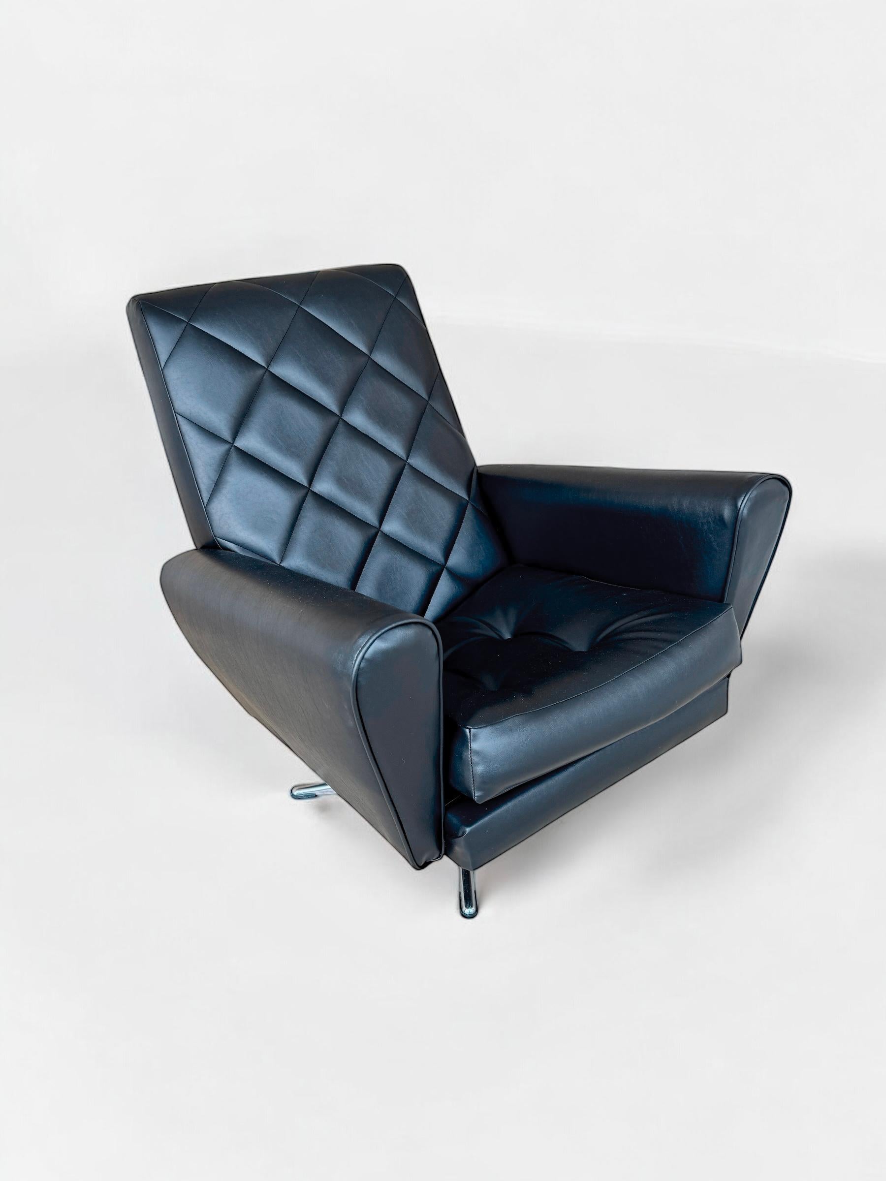 Space Age 1960's James Bond style swivel armchair, France 1960's designed with a slick outline and design with a black leatherette cover the laid back seating position is incredibly comfortable and well suited for a lounge room setting.