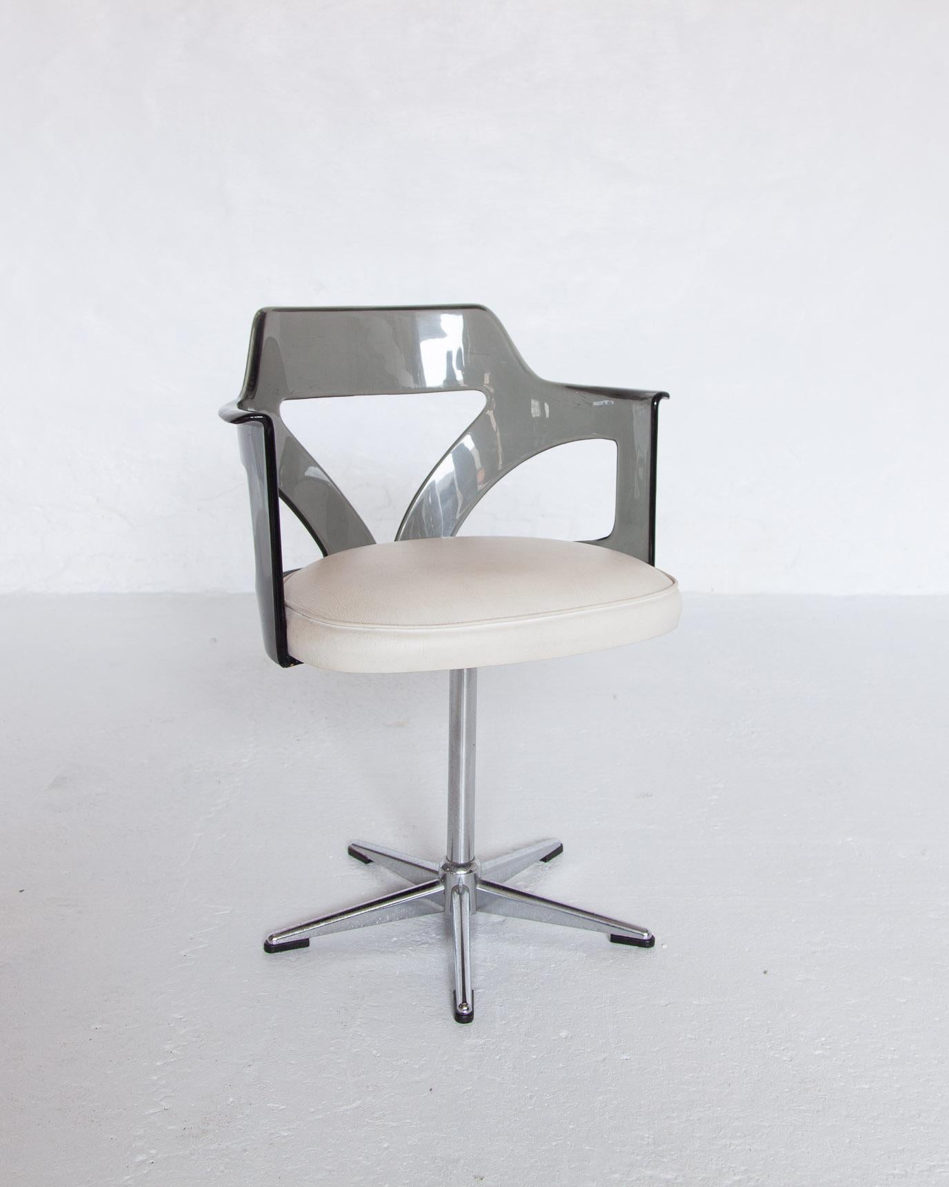 A beautiful vintage modern smoked lucite desk arm chair and a swivel base. The thick padded seating covered in white leather and sculpted design add to the Midcentury Spage age appeal. The chairs are in original good condition, some sign of use.