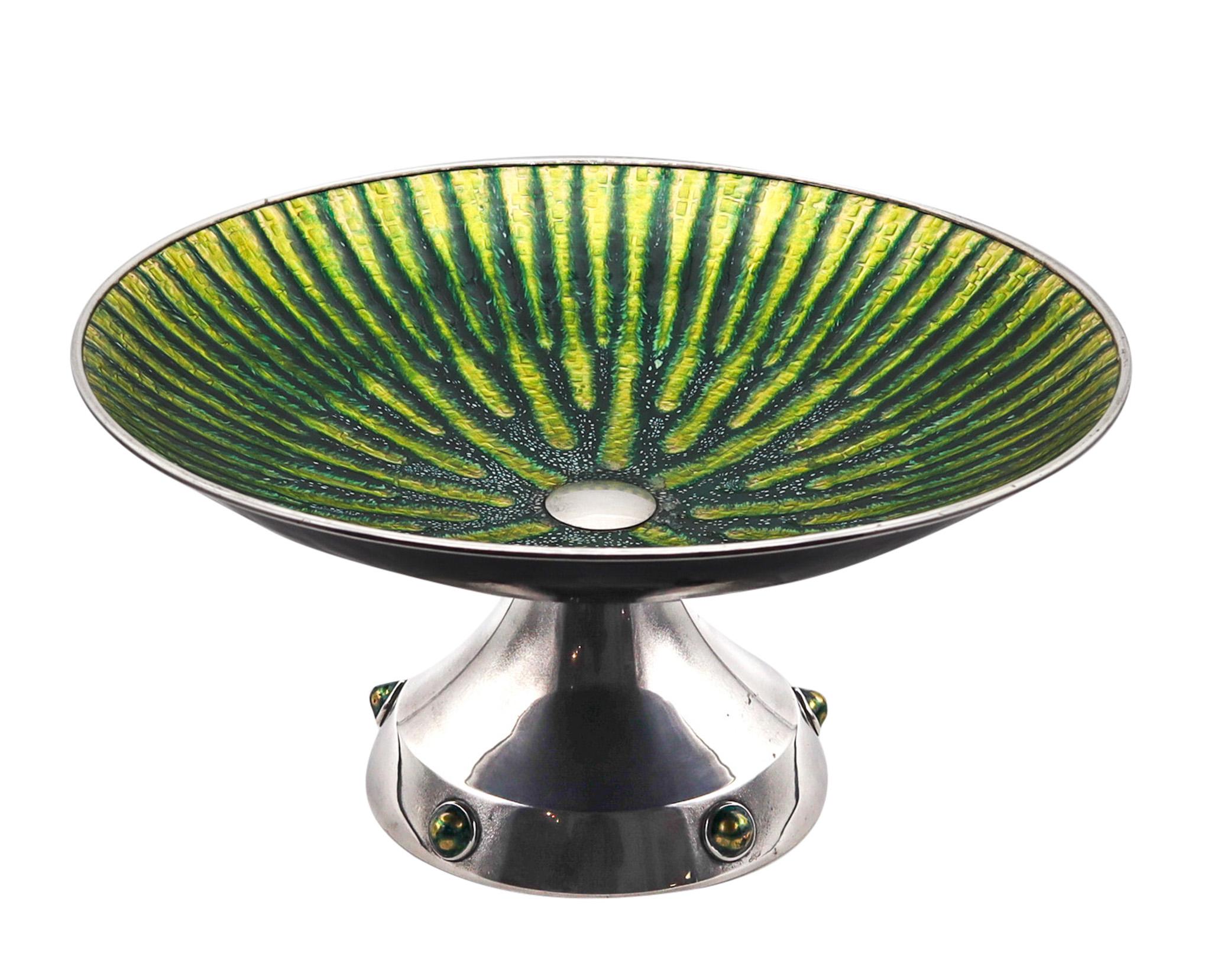 Enameled center piece made in Barcelona

An extraordinary piece of Spanish silversmith, created in the city of Barcelona during the post war mid century period, in the 1950. This oversized massive center piece display very well and has been