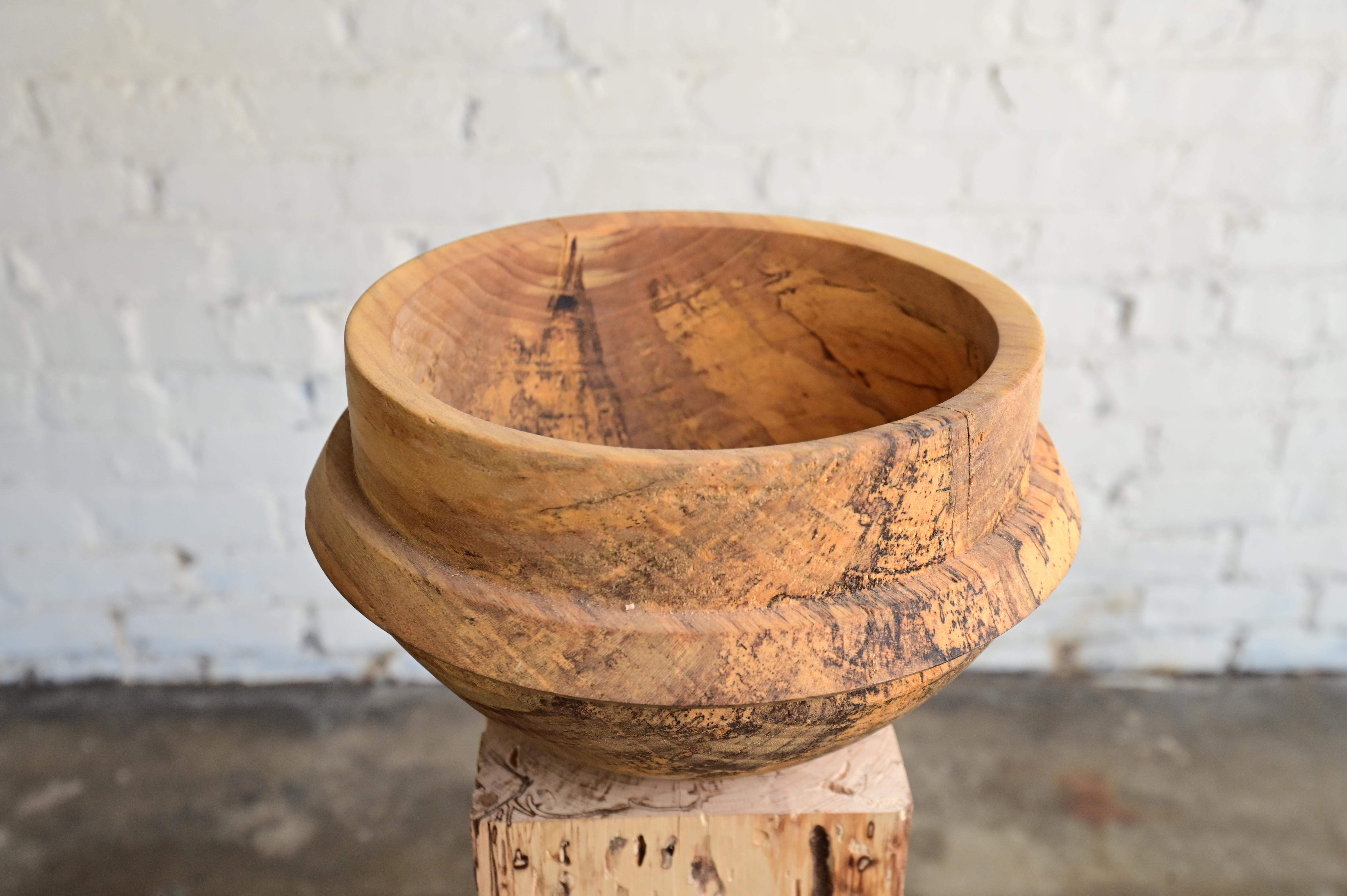 wooden bowl on pedestal