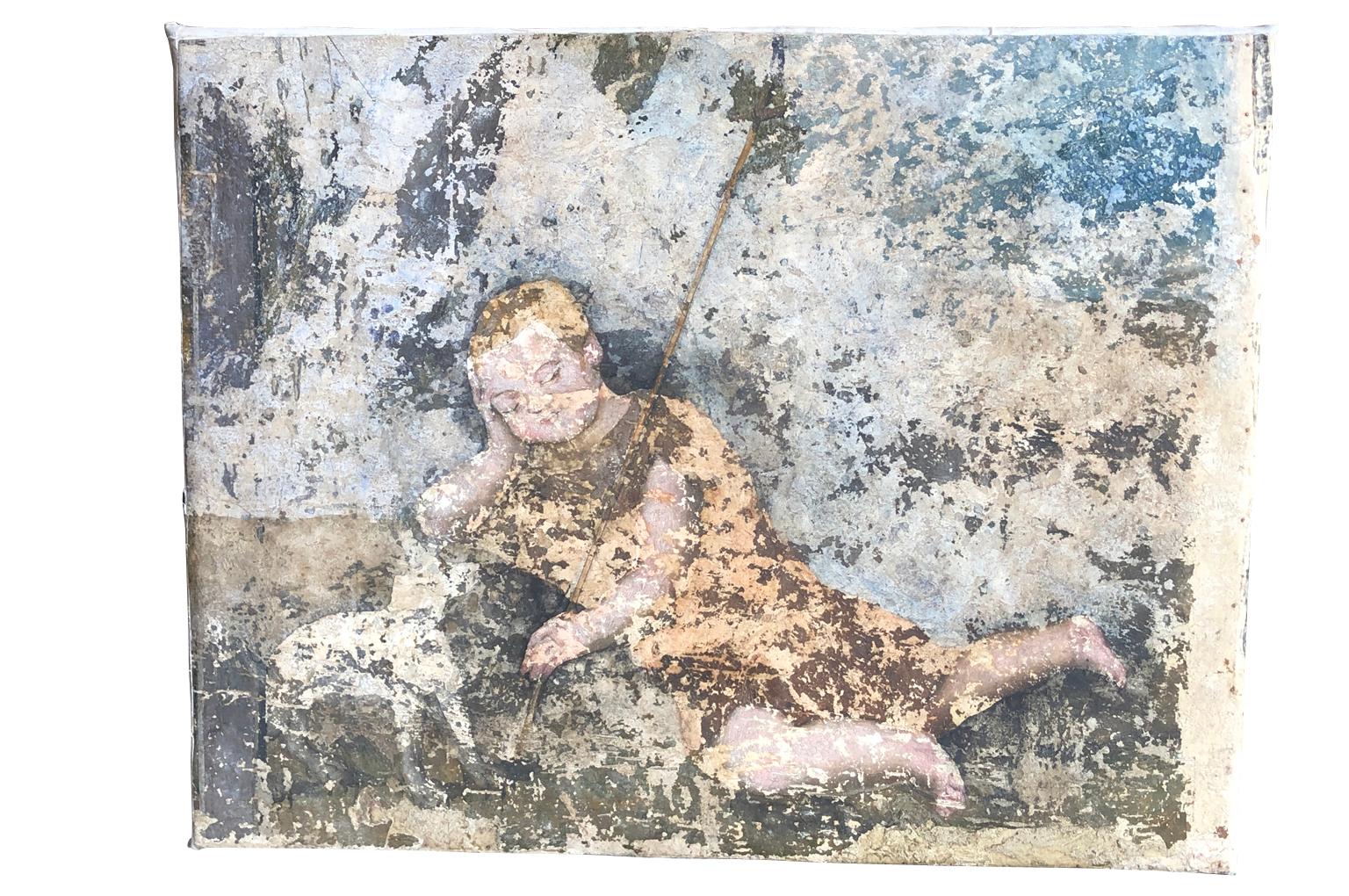 Une merveilleuse fresque du XVIe siècle représentant un très jeune Saint Jean Baptiste, récupérée puis transférée sur toile. Usure et patine étonnantes, palette très douce.