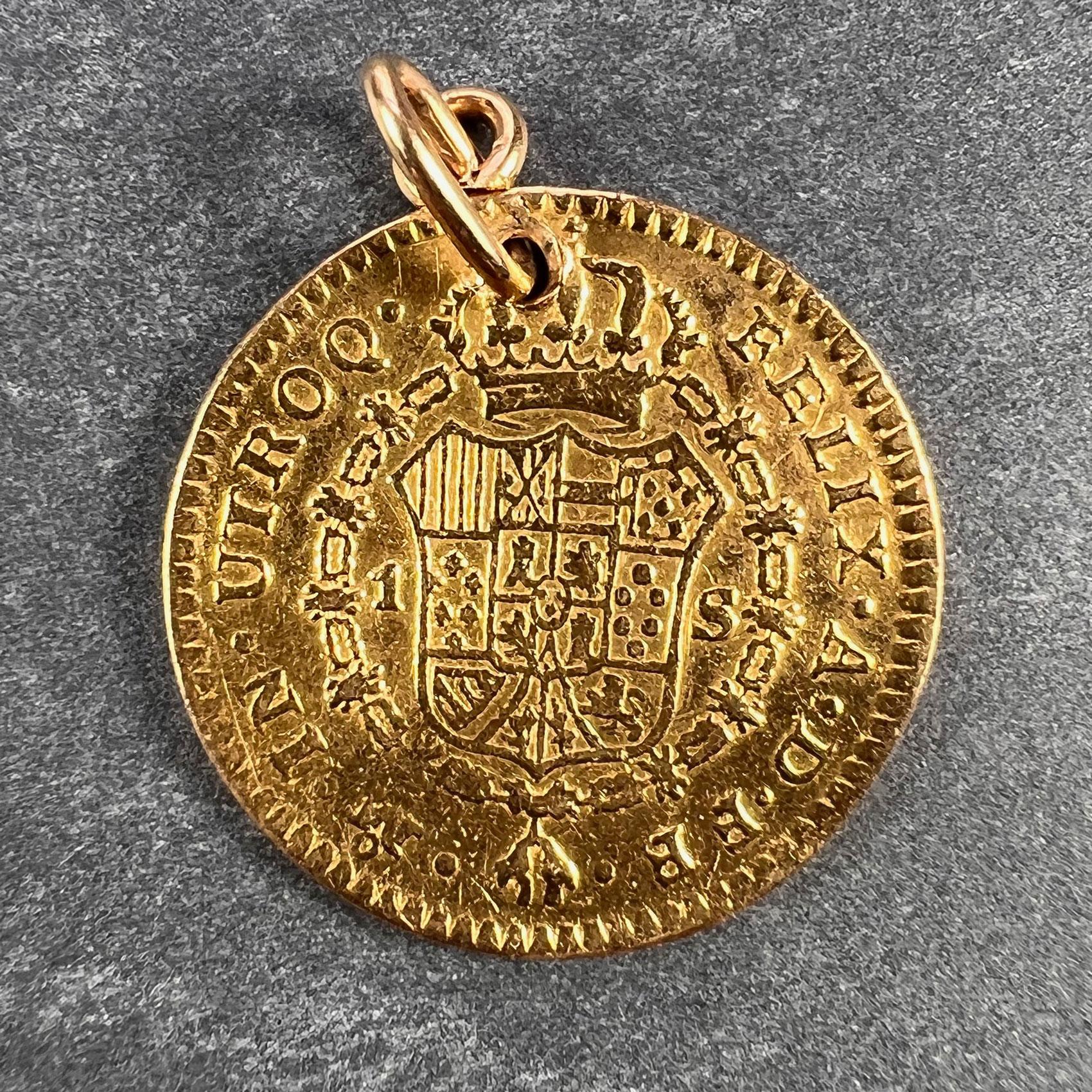 A 22 karat (22K) yellow gold charm pendant being a 1 Escudo coin dating from 1785 depicting Carlos III to one side and the arms of Spain to the other. Minted in the Royal Mint of Spain, Madrid. Drilled to be worn as a pendant.

Dimensions: 1.85 x