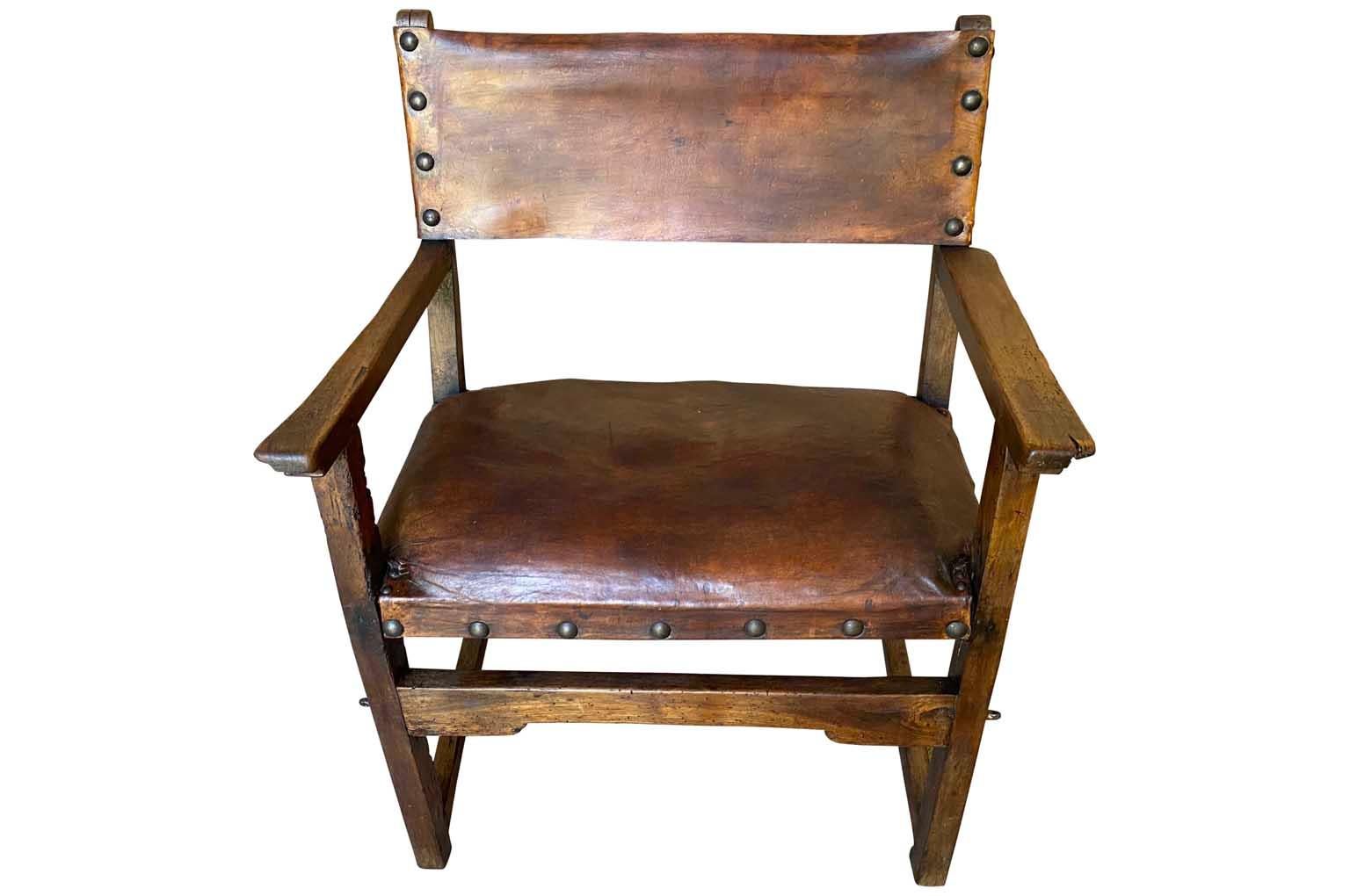 A very handsome 17th century armchair from Spain. Beautifully crafted from leather and walnut. Sumptuous patina - rich and luminous. The seat height is 20 1/4