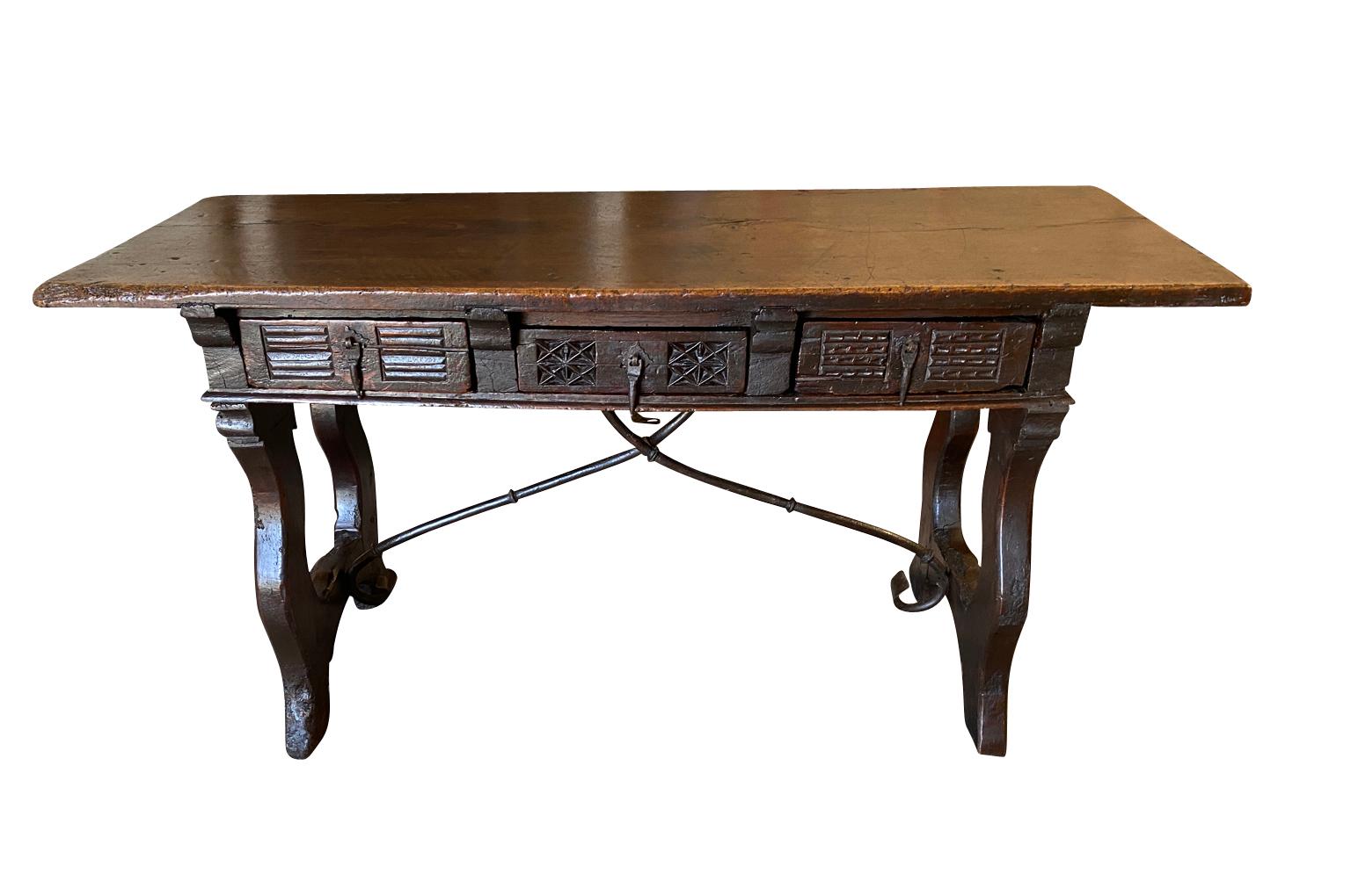 A very handsome 17th century Console Table - Writing Table from the Catalan region of Spain.  Beautifully constructed from walnut with a solid board top, 3 drawers with unique fascia carvings, hand forged iron stretchers and lyre shaped legs. 