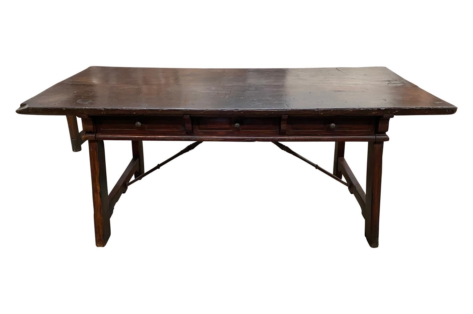 A stunning 17th century desk from Northern Spain. Beautifully constructed from chestnut and pine woods with three drawers and hand forged iron stretchers. Gorgeous patina - rich and luminous.