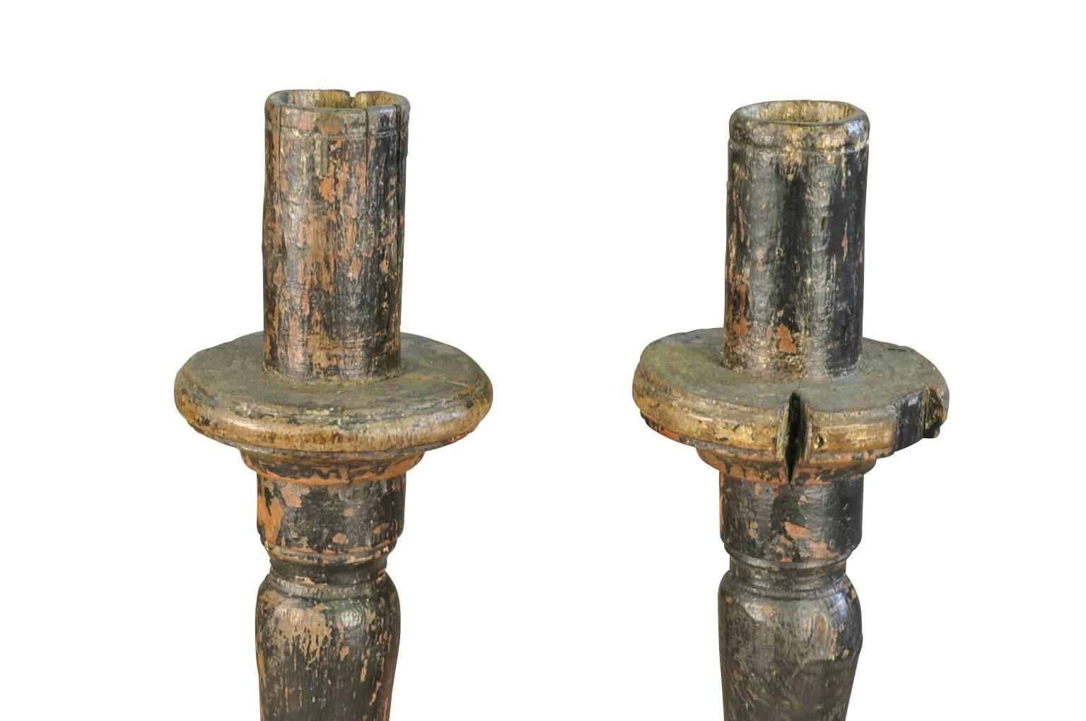 A wonderful pair of 17th century large altar sticks from the Catalan region of Spain. Handsomely constructed from painted wood with a nicely turned shaft on tripod feet. Terrific patina.