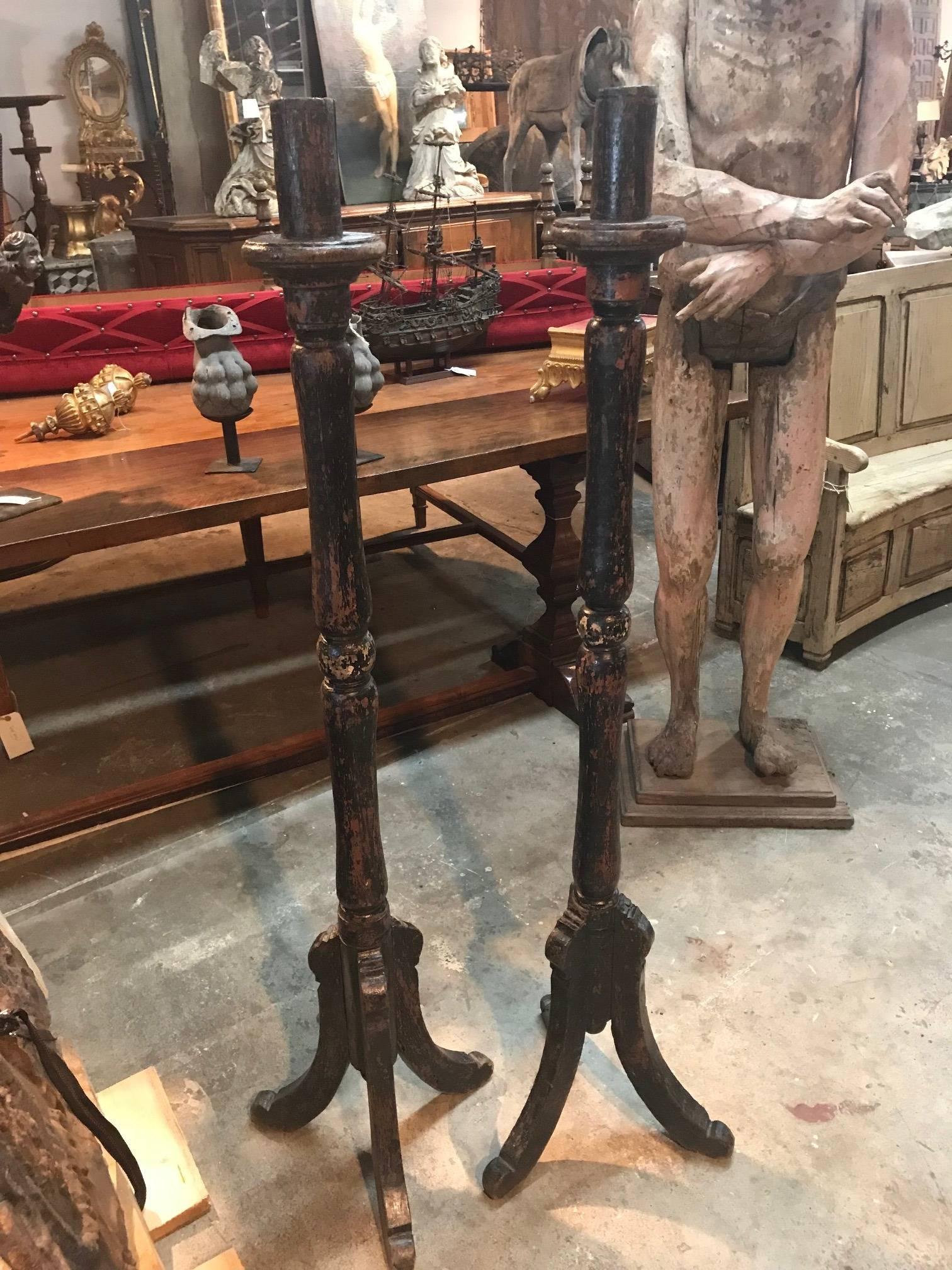 A wonderful pair of 17th century large altar sticks, altar torcheres from the Catalan region of Spain. Handsomely constructed from painted wood with a nicely turned shaft on tripod feet. Terrific patina.