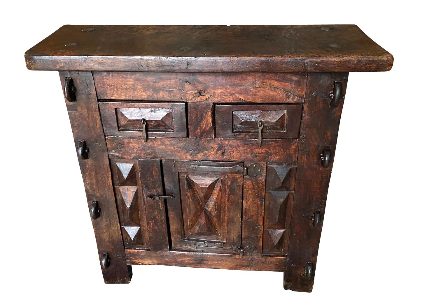A fantastic late 17th century Buffet from the Spanish Pyrenees region.  Wonderfully constructed in richly stained oak with 2 drawers and a single door with beautifully sculpted panels and handsome hardware throughout.  Super patina - rich and