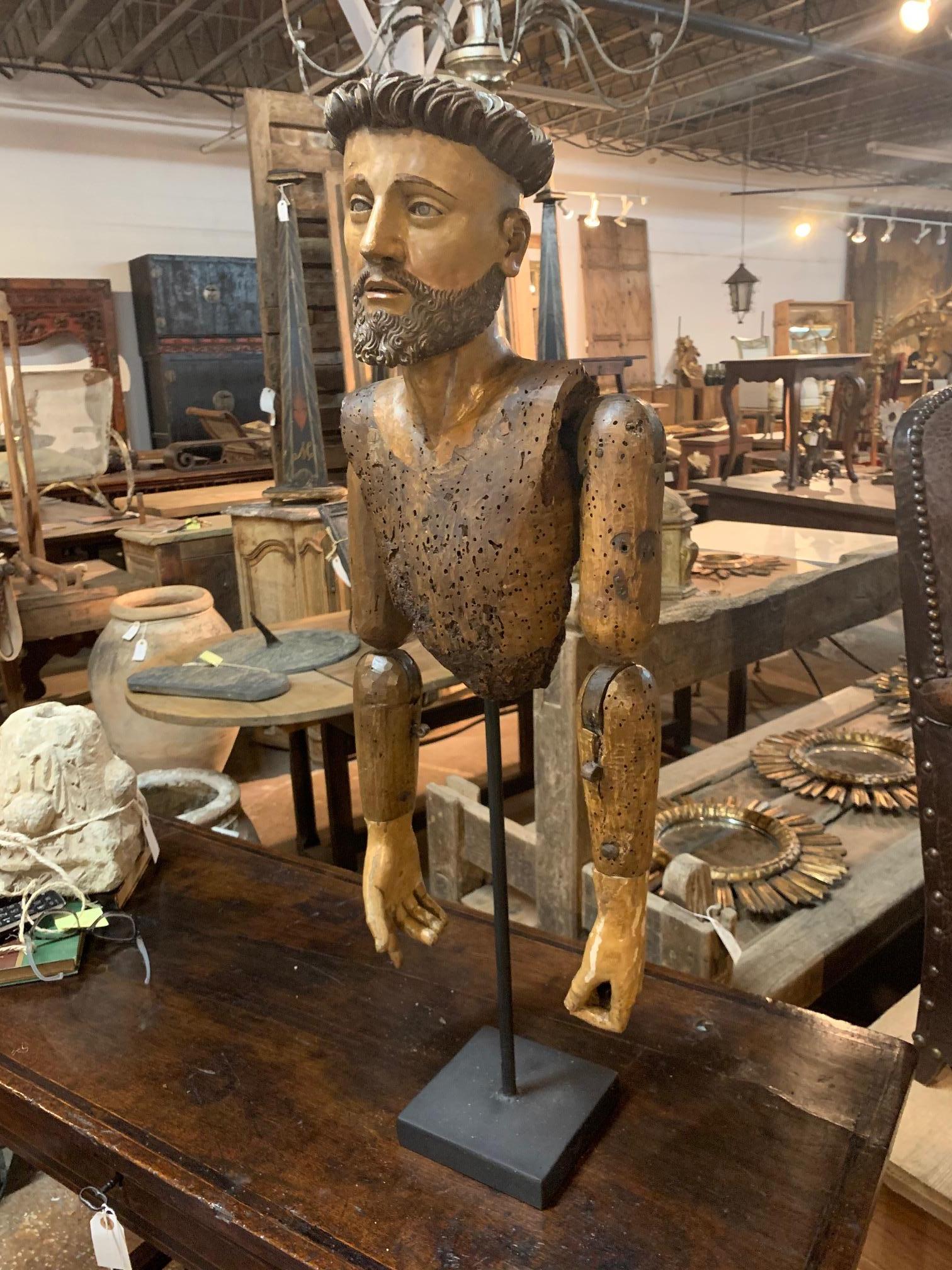 An excellent 17th century Spanish Santo fragment - the head and torso - in hand carved polychromed wood. A wonderful art piece now mounted on a custom iron presentation stand.