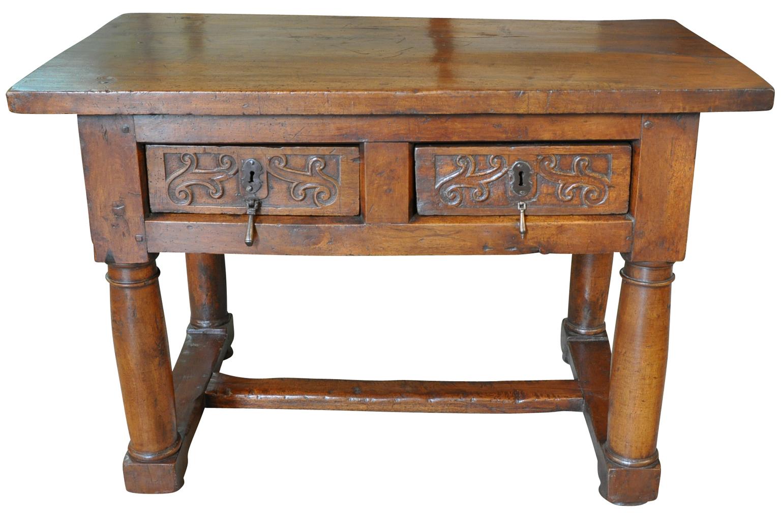 A very handsome and very sound 17th century side table from the Catalan region of Spain. Wonderfully constructed from beautiful walnut with a tremendous solid board top, two drawers with lovely carving detail and substantial turned legs. Wonderful