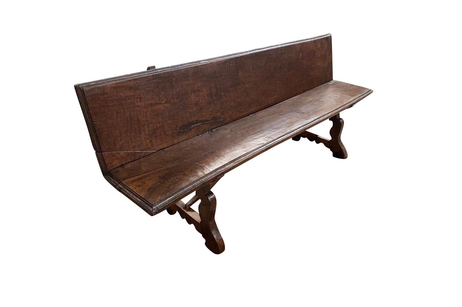 A very handsome 18th century Spanish bench constructed from solid board planks of walnut. Sensational patina. The seat height is 18 5/8