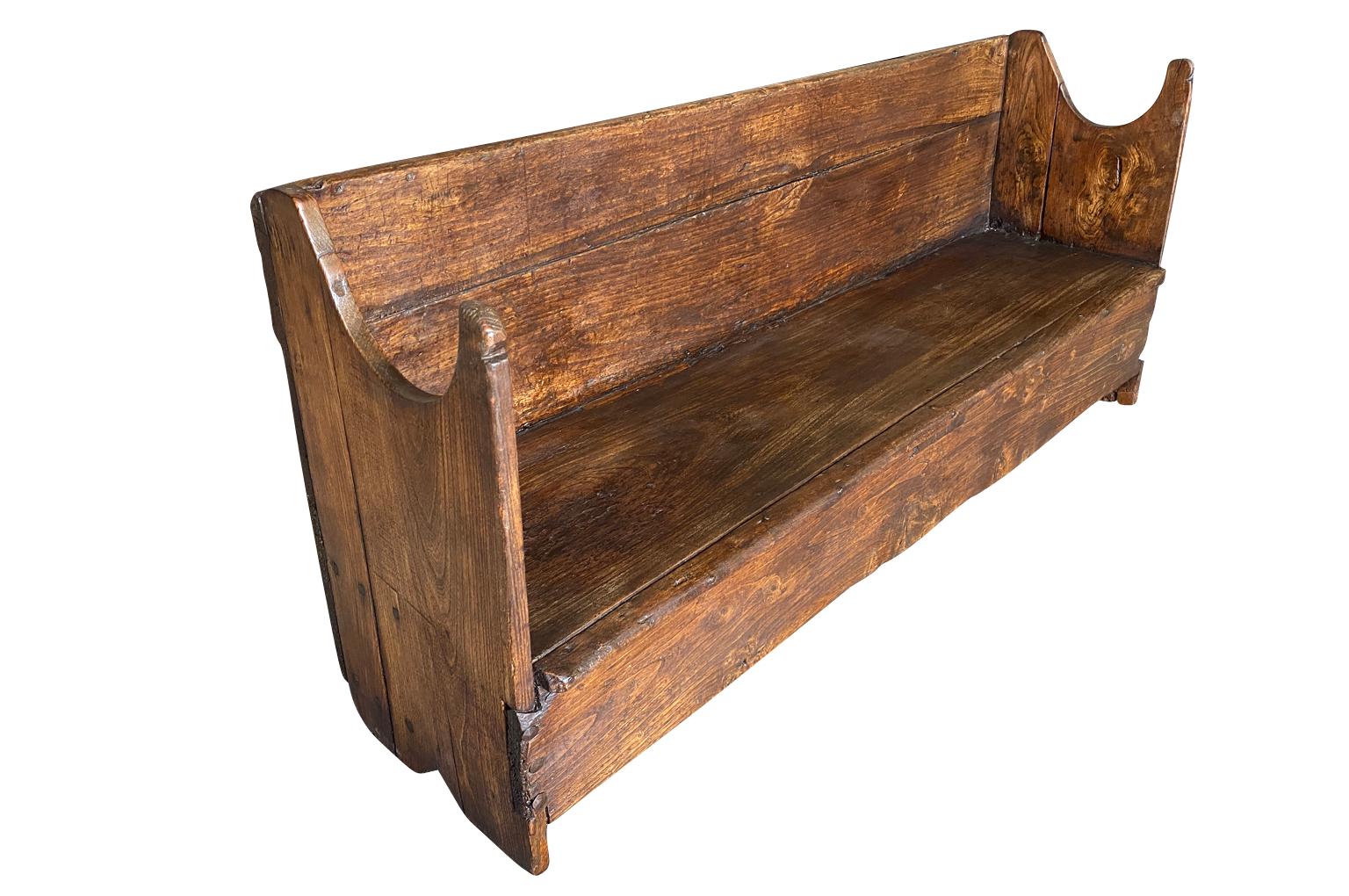 A very charming 18th century primitive Bench from the Catalan region of Spain.  Soundly constructed from chestnut and pine with back and sides.  The seat height is 14