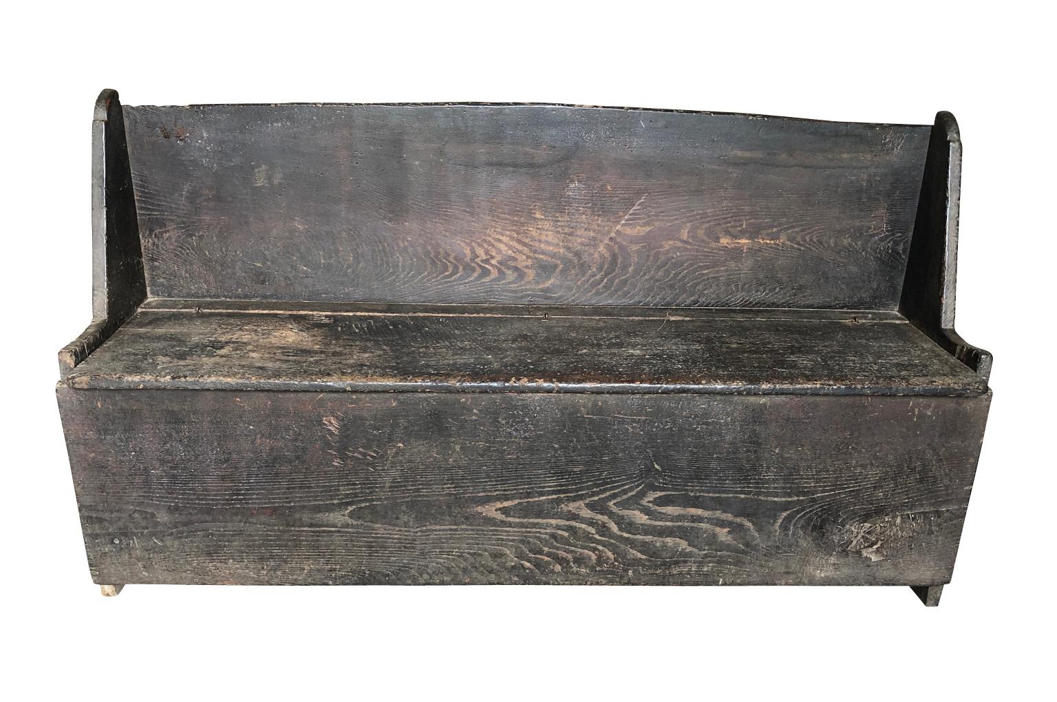 A very handsome primitive 18th century bench, trunk from the Catalan region of Spain. Soundly constructed from beautiful chestnut with very minimalists lines. The seat lifts to expose storage space. Great patina.