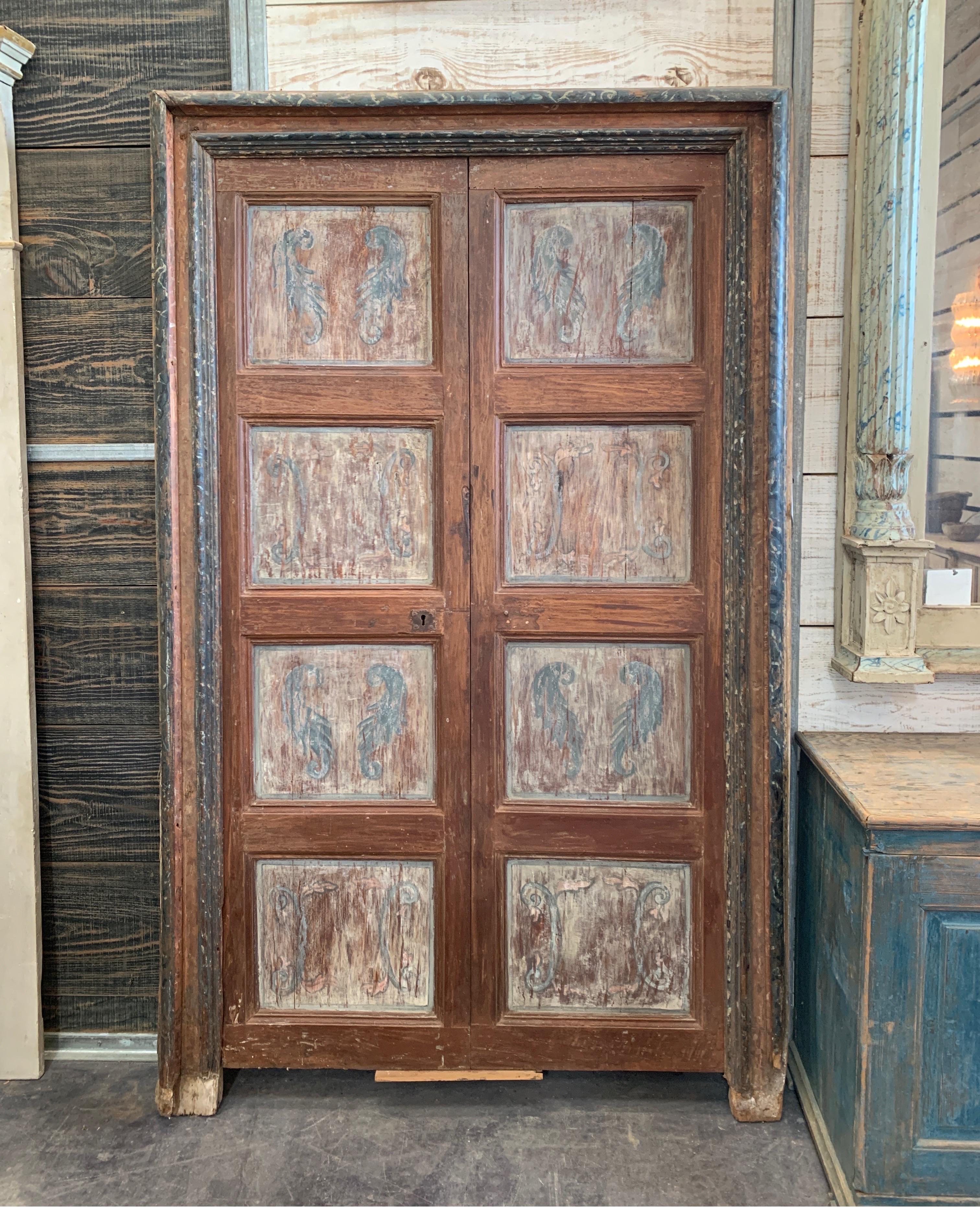 These early Spanish door are full of character and charm with the original iron hardware on back and front. Just the handle is missing. The surround has gorgeous colors of blue and black marble effect. The door measures 44 W x 84.5 T without the