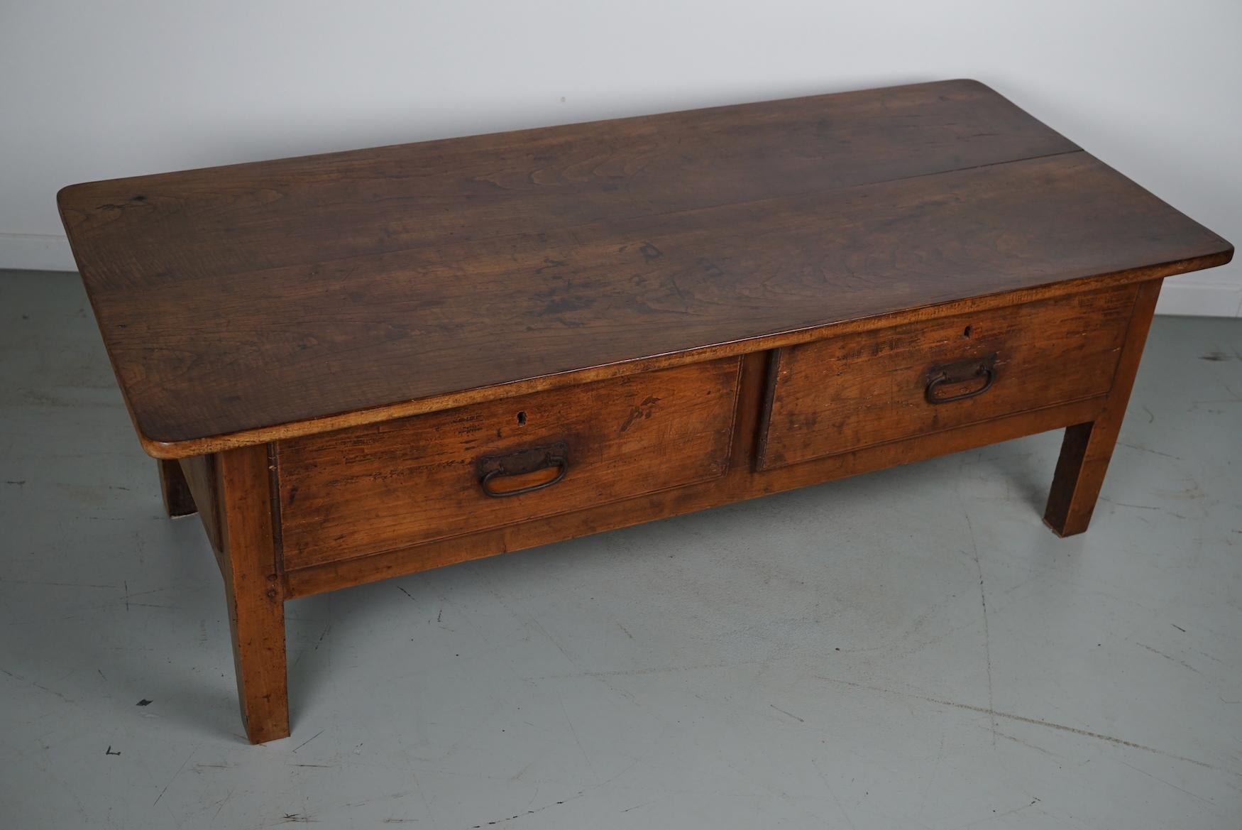 This coffee table was converted from an old 18th century chestnut farmhouse prepping table. It retained a very nice patina and rich color / fading over the years and has a practical size with large drawers.