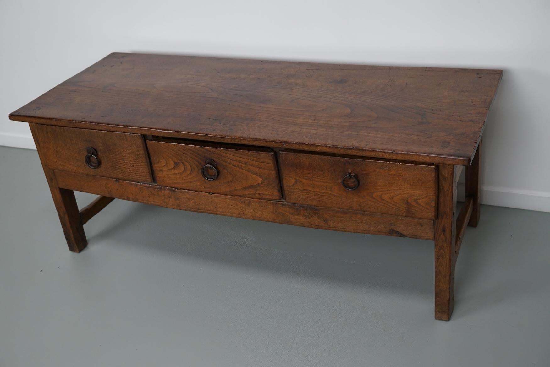 This coffee table was converted from an old 18th century chestnut farmhouse prepping table. It retained a very nice patina and rich color / fading over the years and has a practical size with three drawers.