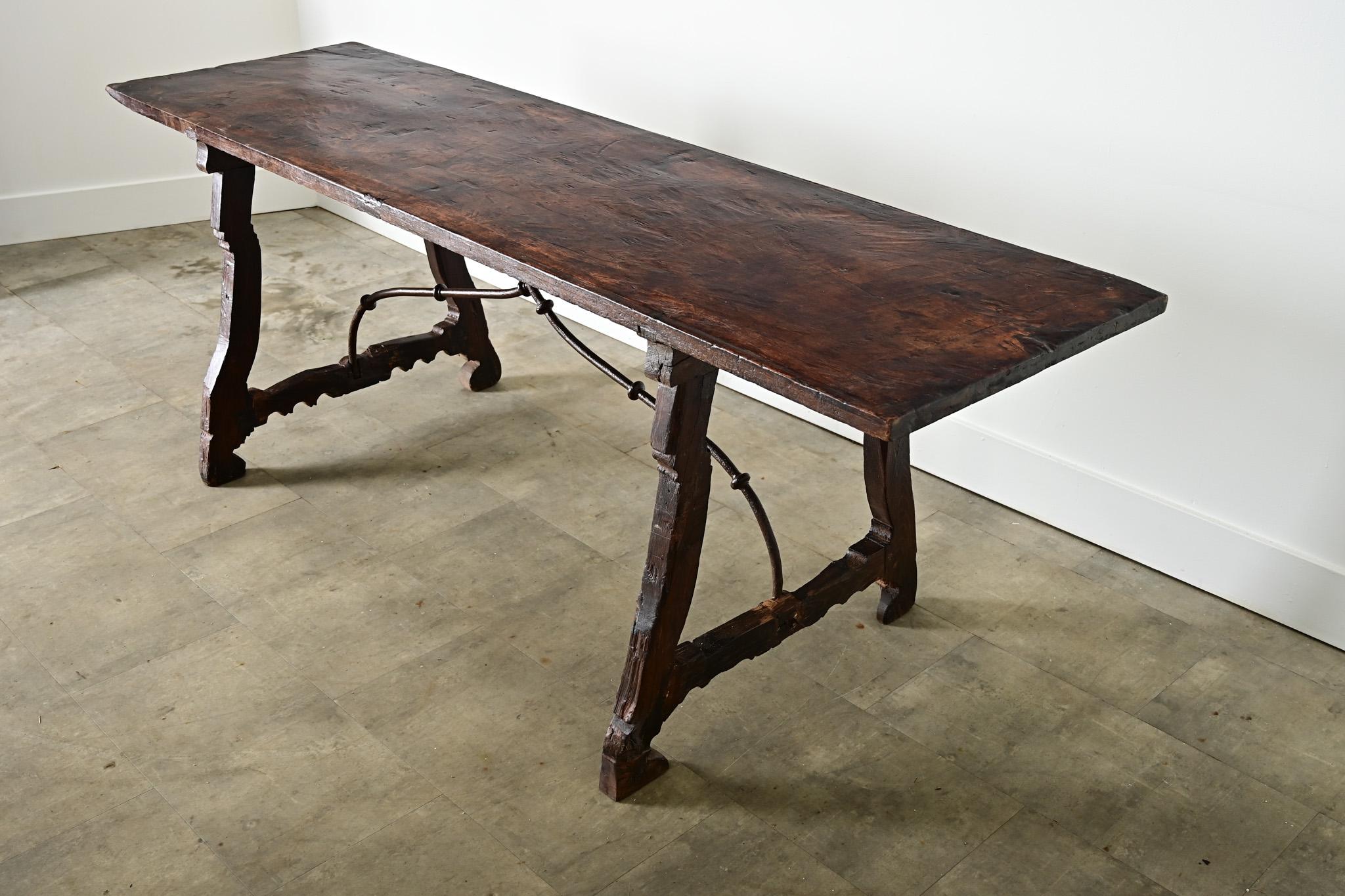 A Spanish refectory or fratino table from the 18th century–traditionally used in abbeys–this multipurpose table easily adapts to a console, dining table, or writing desk for practically any interior. The single plank top is supported by an exquisite