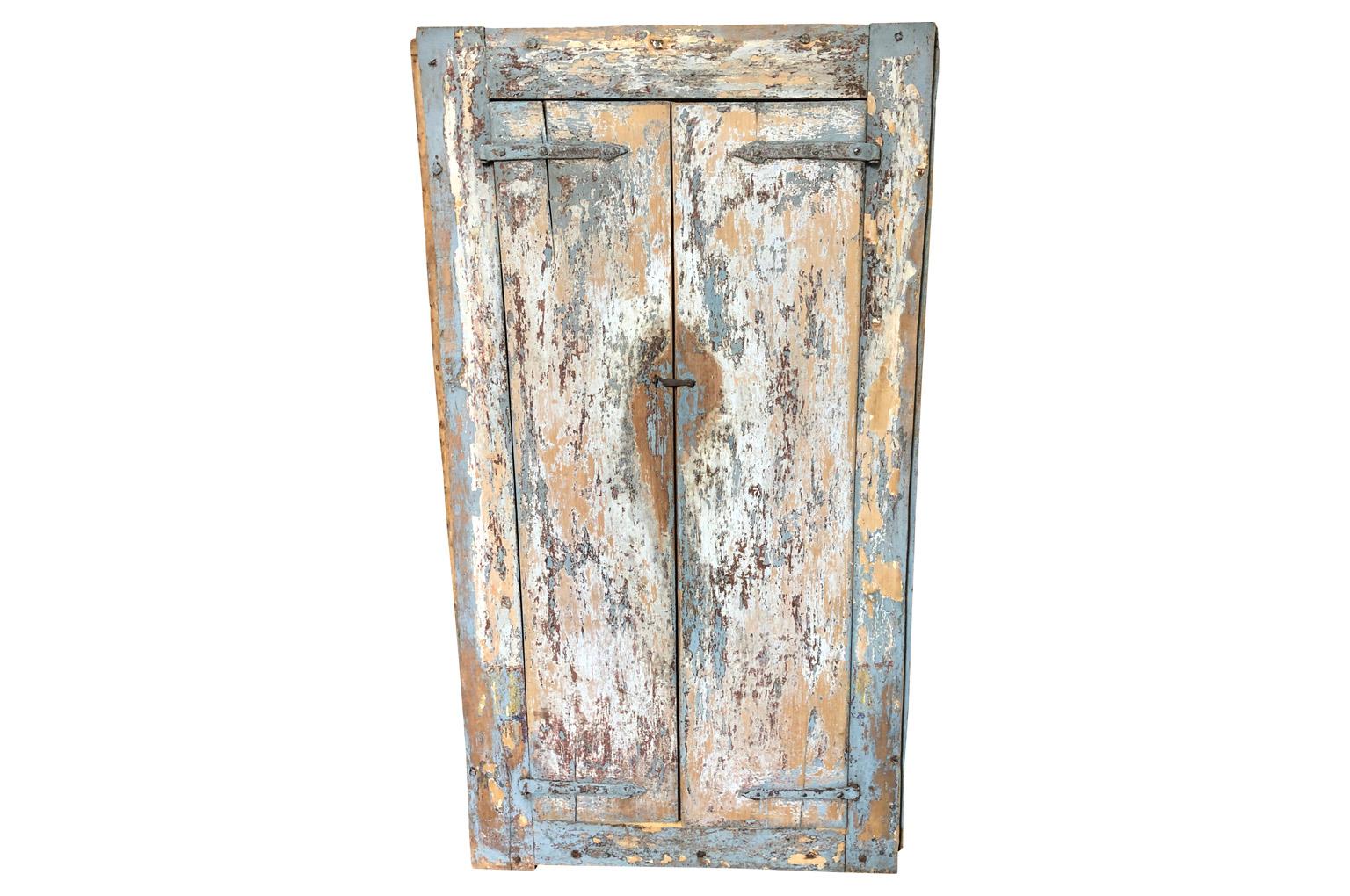 A very charming 18th century primitive armoire from Spain. Wonderful diminutive scale. Soundly constructed from painted wood. Super patina.