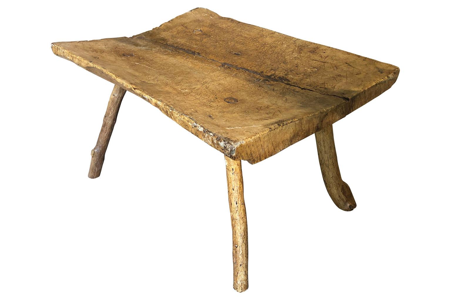 A very charming 18th century Primitive bench - coffee table - wonderfully constructed with a solid board top in naturally washed elm from the Catalan region of Spain. Wonderful for any casual interior or exterior.