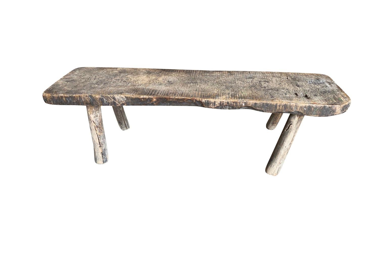 A very charming primitive bench - coffee table from the Catalan area of Spain.  Soundly constructed from beautiful beech wood with a wonderful thick top.  Wonderful graining and patina.  Perfect for any modern or rustic environment. 