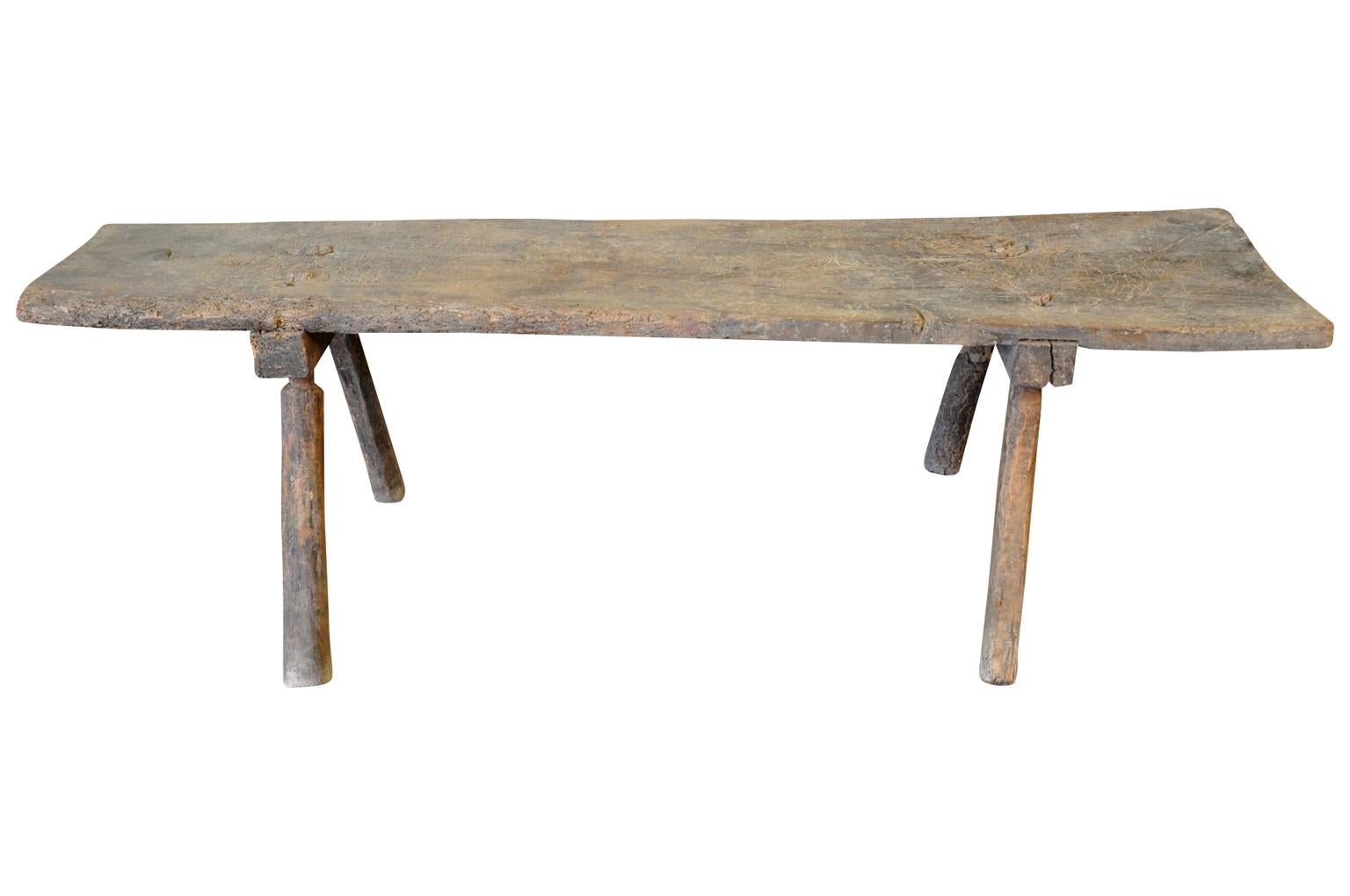 A very charming 18th century primitive bench from Northern Spain. Soundly constructed from naturally washed chestnut - with a solid board seat and splayed legs. Terrific patina. Also wonderful as a coffee or cocktail table.