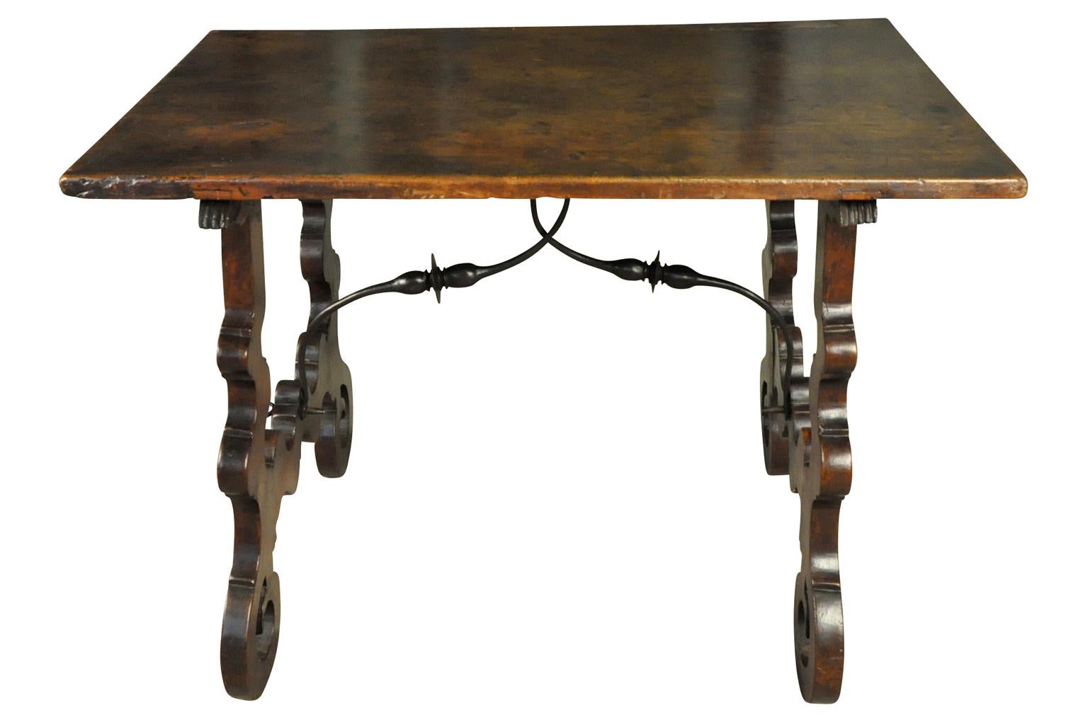 An outstanding 18th century side table from the Catalan region of Spain. Beautifully and soundly constructed from stunning walnut, hand forged iron stretchers and classical lyre shaped legs. This table has a beautiful solid board top. Sensational