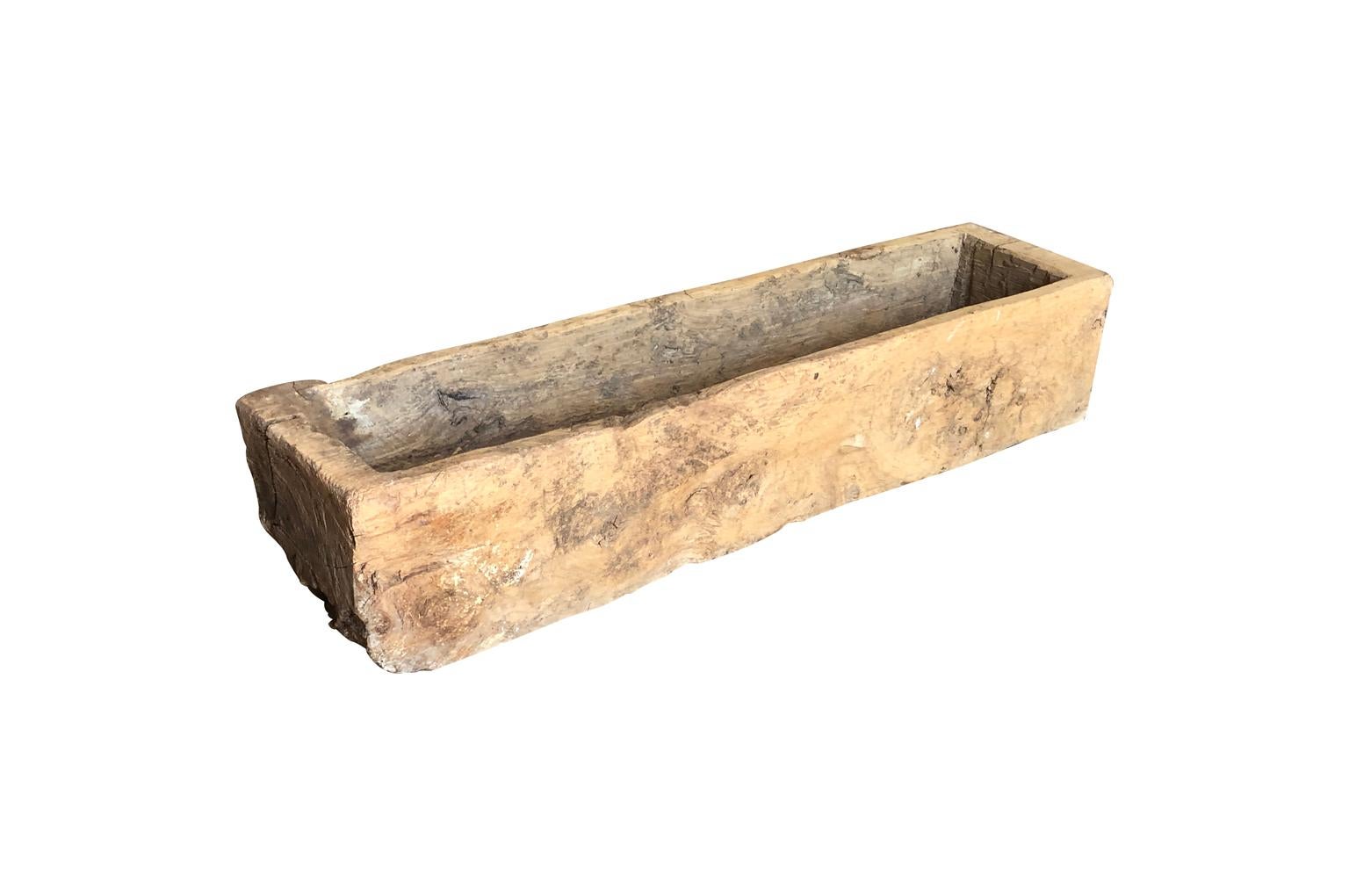 A very handsome primitive trough from the Catalan region of Spain. The trough is beautifully carved from a large solid block of wood. Serves wonderfully as a planter or a center piece to a farm table.