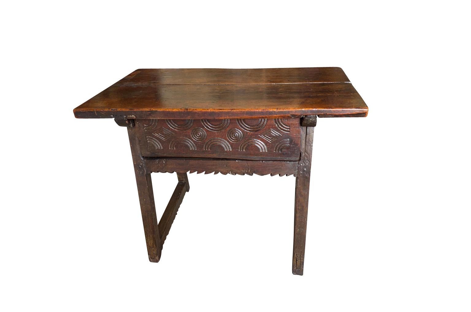 A wonderful mid-18th century side table in beautiful walnut & chestnut from the Catalan region of Spain. Soundly constructed with single drawer with charming carvings to its facade. Excellent patina.