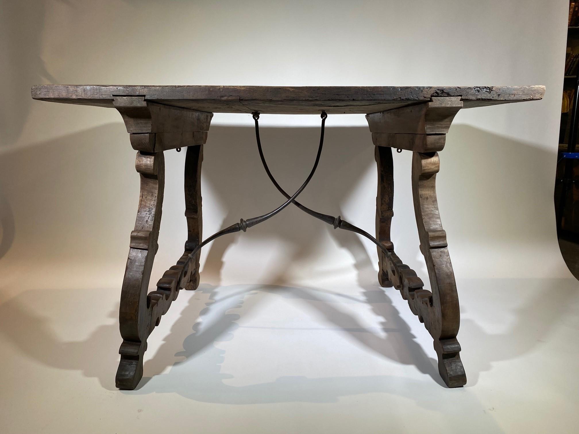 An exceptional and very beautiful mid-18th century writing table from the Catalan region of Spain. Beautifully constructed from stunning walnut with a solid board top and hand forged iron stretchers. Fabulous patina and graining.