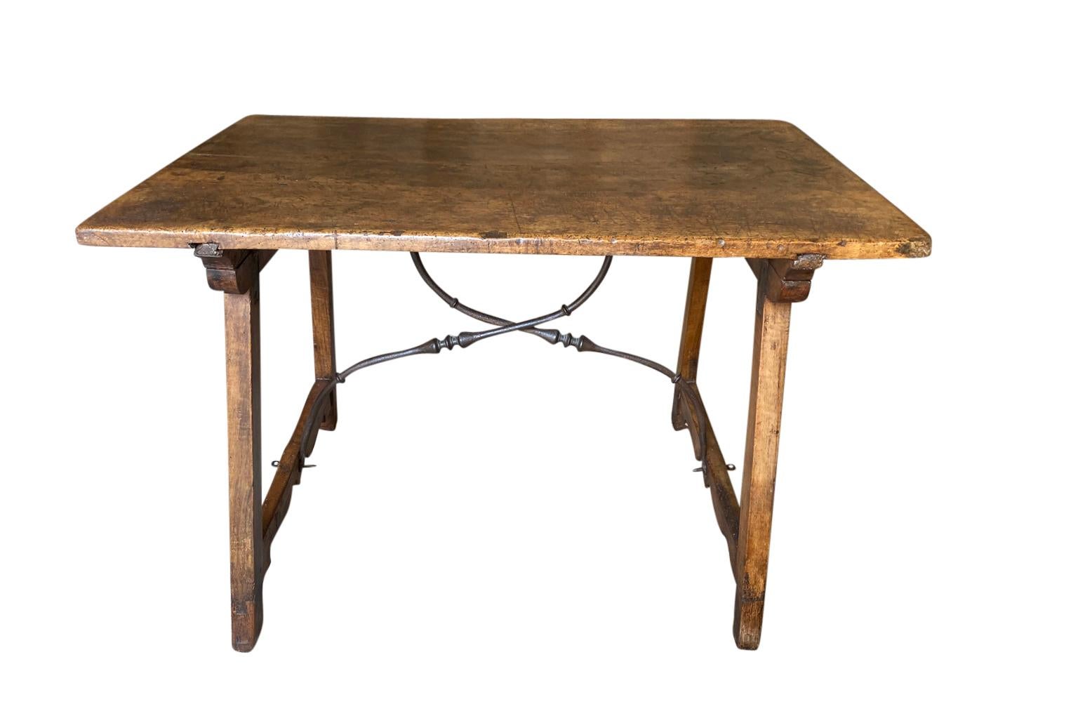 A stunning 18th century Traveling Table - Writing Table from the Catalan region of Spain. Beautifully constructed from stunning walnut with a solid board top and hand forged iron stretchers. The table is designed to collapse. Gorgeous patina - warm