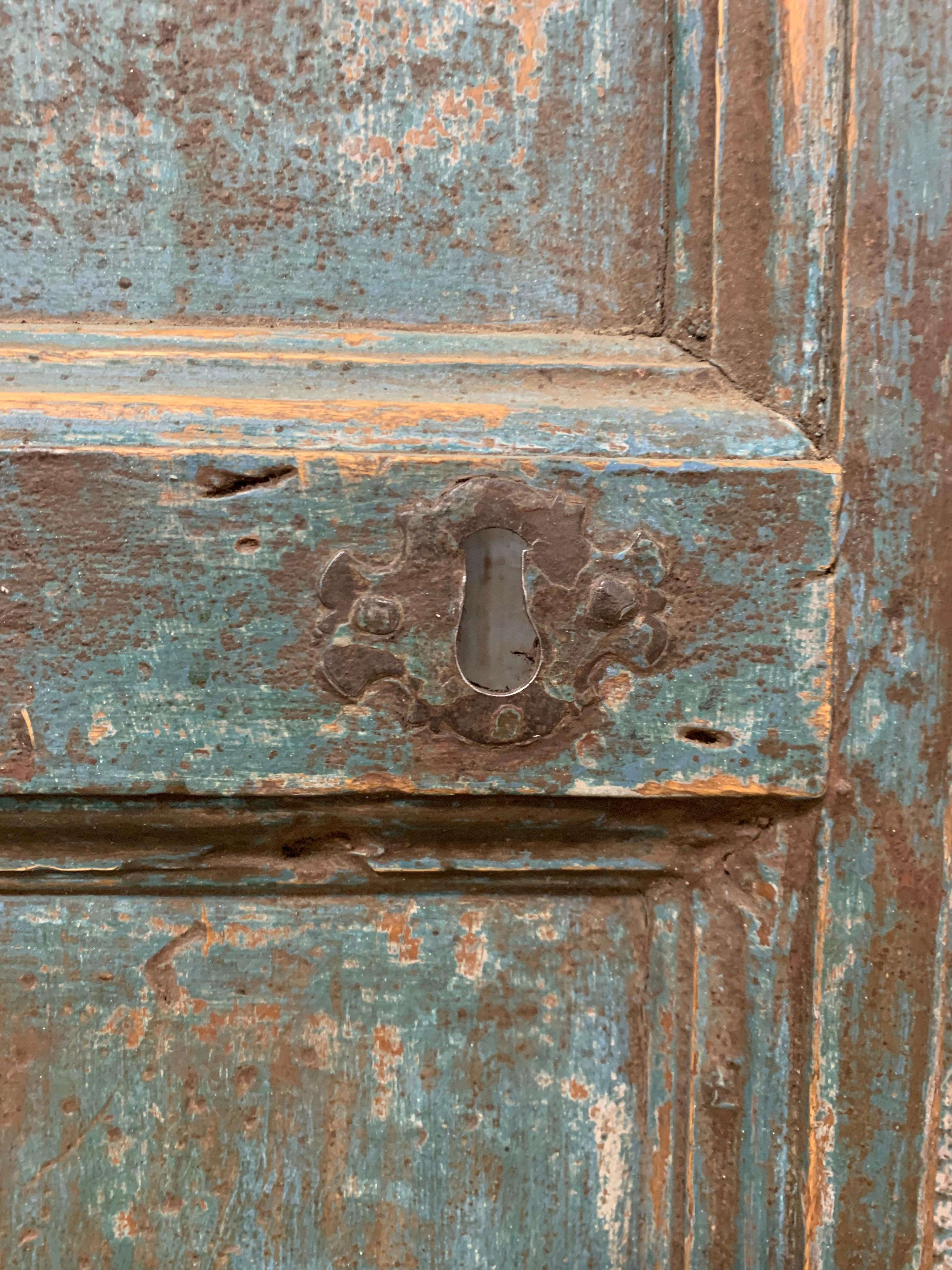 Beautiful faded teal polychrome paint, makes this antique Spanish door beautiful.  It makes for a great powder room door or wine cellar door as well.
