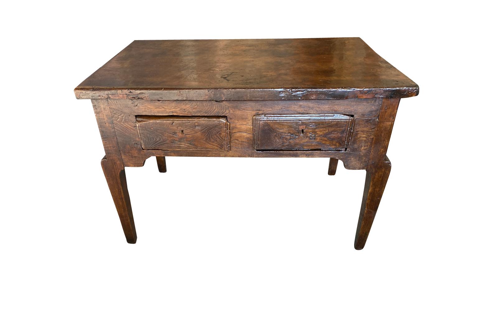 A very beautiful 18th century writing table - side table from the Catalan region of Spain. Wonderfully constructed from chestnut with a stunning solid board top, 2 drawers over tapered legs. Stunning graining and patina.
