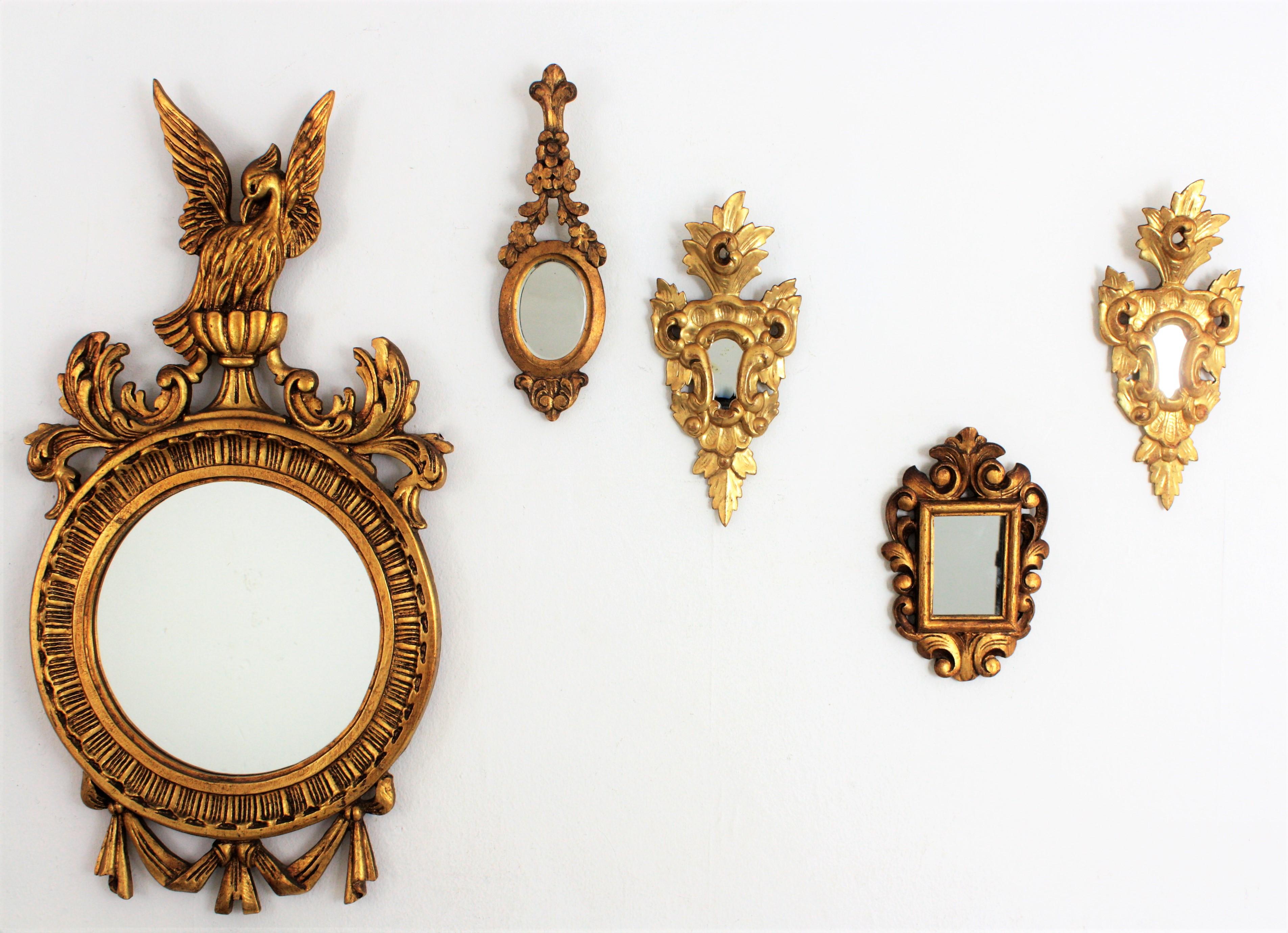 Beautiful carved wood small mirror finished with scroll decorations at the frame and gold leaf. It has been restored to preserve its original antique patina. Interesting for collectors and beautiful placed with other miniature mirrors creating a