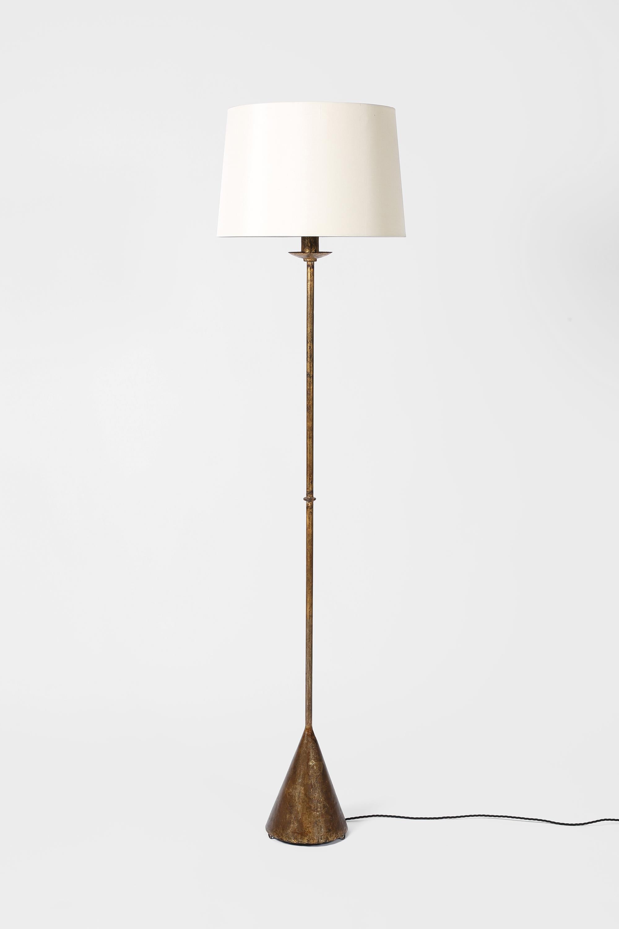 A rare, gilt and beautifully patinated iron floor lamp by Valenti. Simplistic in form with subtle, knopped stem and signature conical base. Spanish, c. 1950s. Supplied with an off-white dupion silk shade.