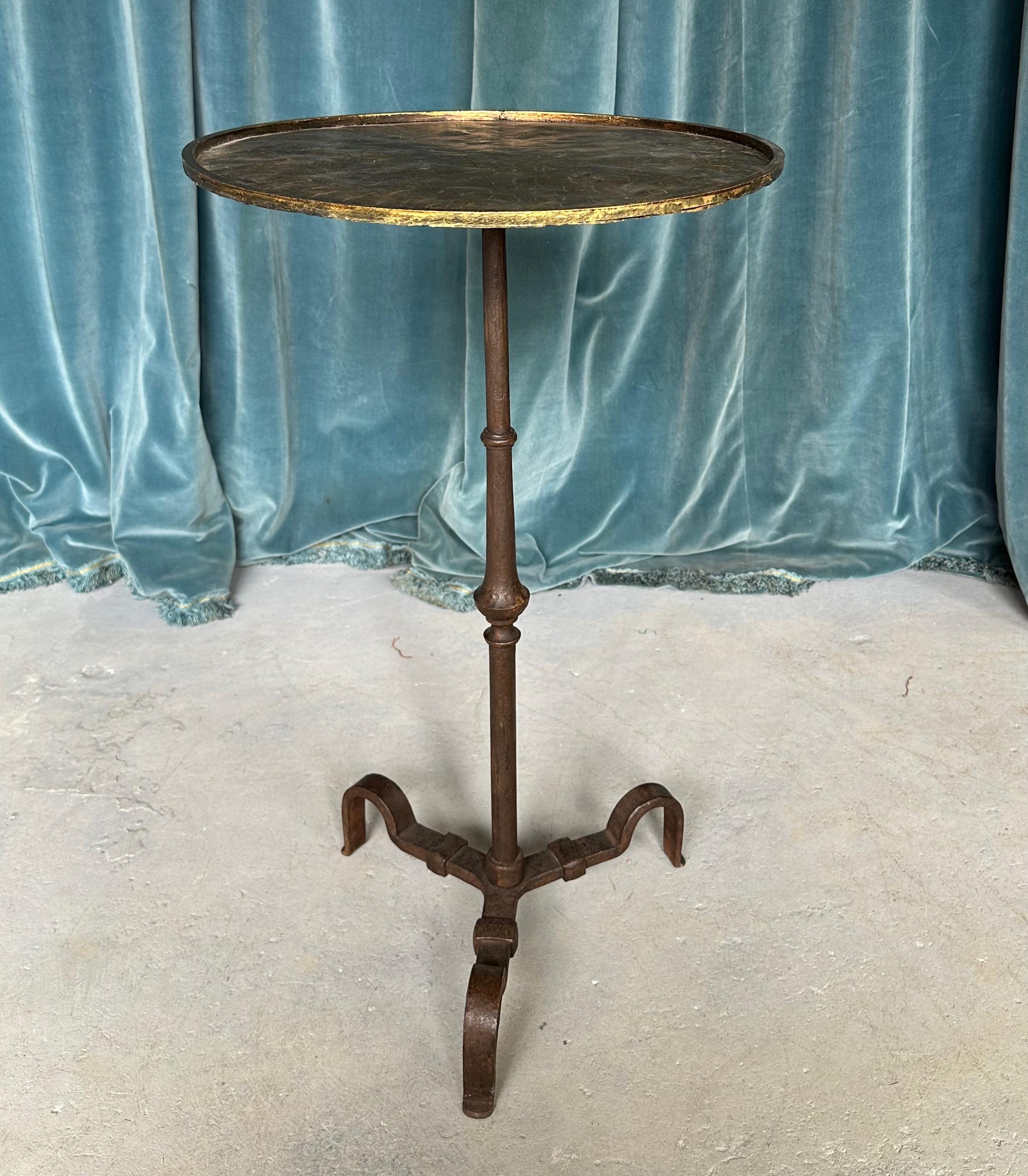 An interesting and elegant Spanish side table from the 1950’s.  Handmade with a wrought iron base and a hammered gilt top, this very well made table is perfect for next to a sofa  and because of its small size it can be used for a private breakfast
