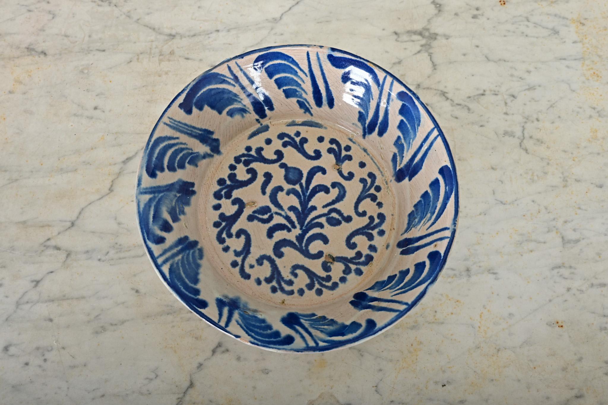A charming, handpainted terracotta lebrillo bowl from Granada, Spain (19th century)–these illustrative ceramic works collectively known as fajalauza pottery can be traced back to at least the 16th century, deeply influenced by the Moorish presence