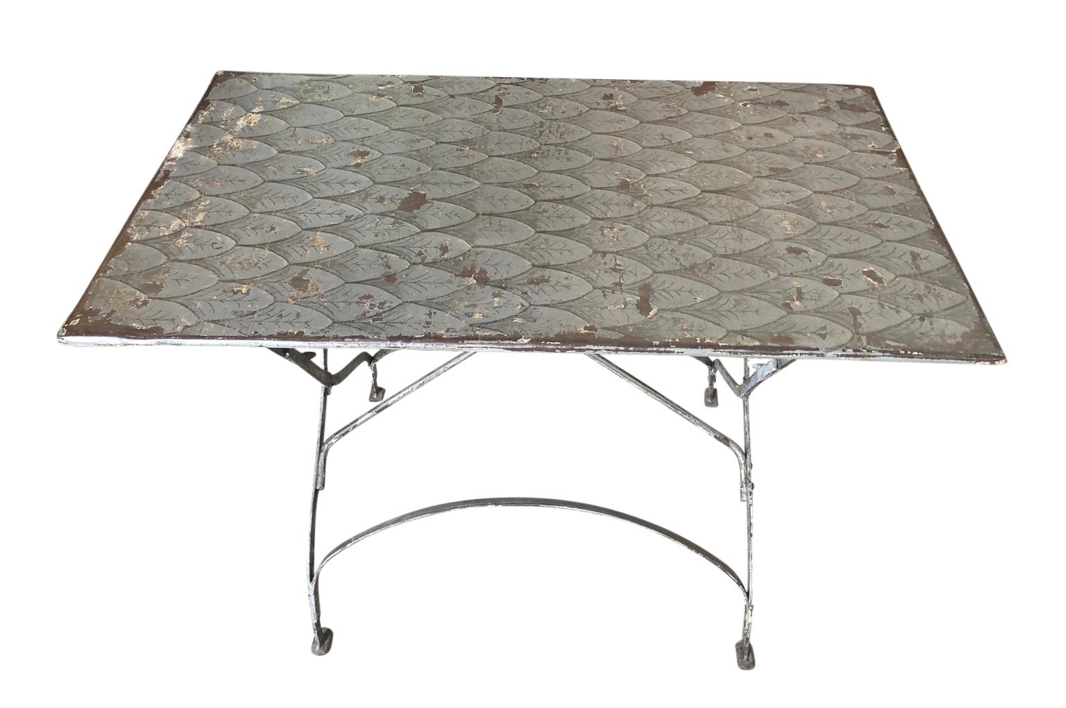 A very charming later 19th century iron collapsible garden table for the Barcelona area of Spain. Fabulous painted finish. A terrific accent piece for any casual interior or garden.