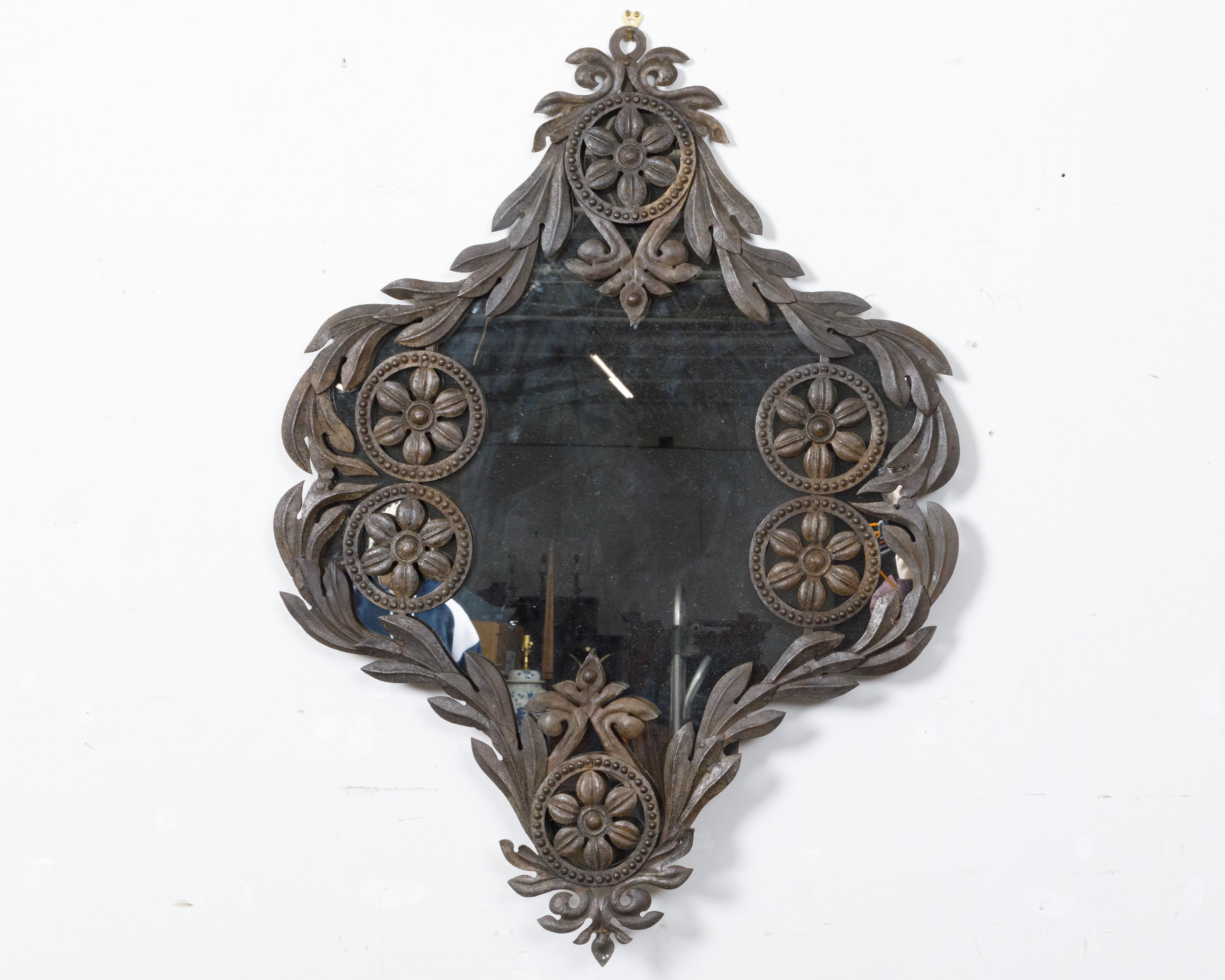 Specchio da parete spagnolo in metallo del XIX secolo con linee curve, rosette e fogliame. Questo squisito specchio da parete in metallo spagnolo del XIX secolo affascina con la sua cornice artistica, ornata da bellissime linee curve, delicate