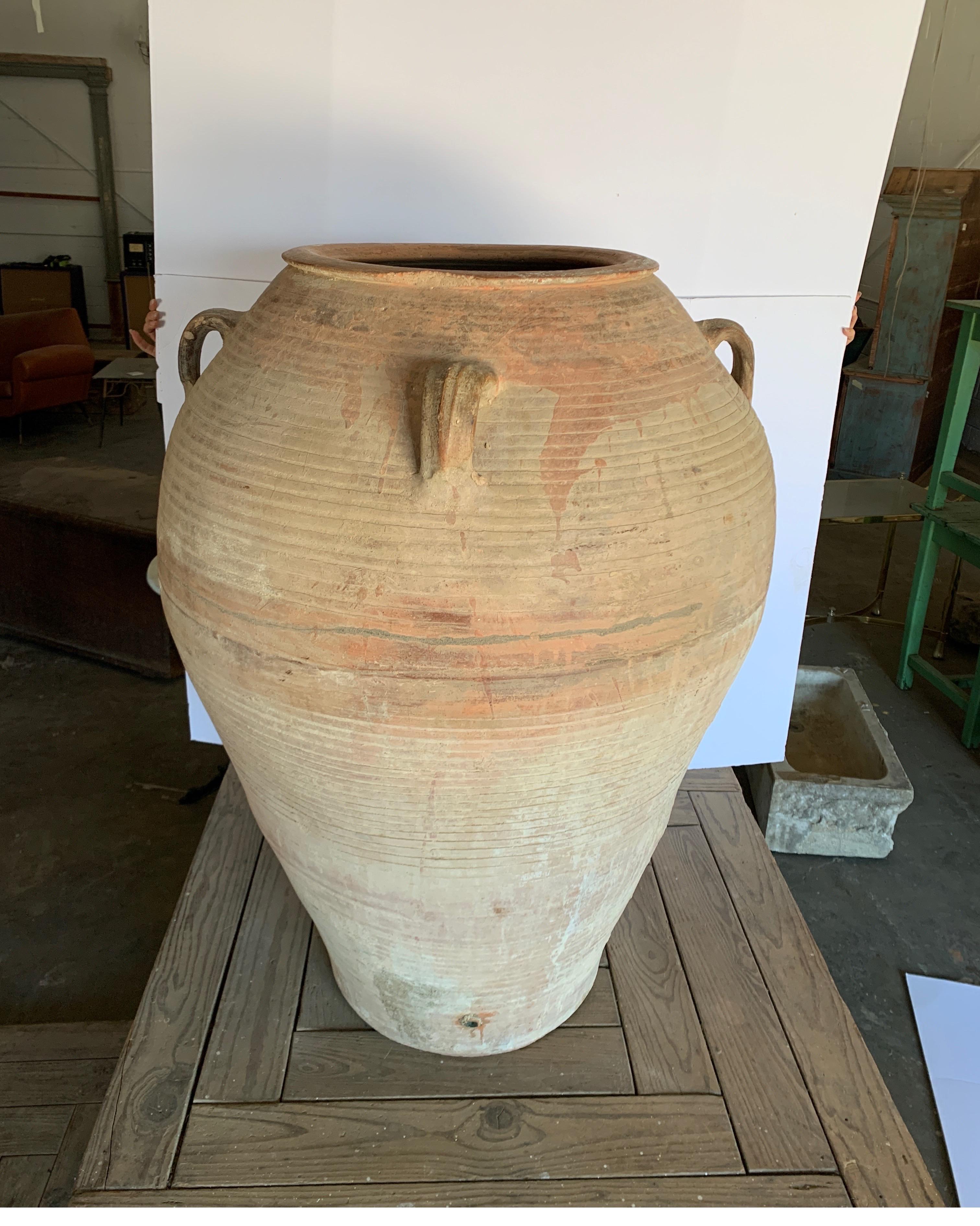 These are large scale Spanish olive jars from Catalonia. It's one of a pair sold separately, each with drain holes pictured. Starting at the 10th photo is the second jar. The opening of the mouth at the top is 17