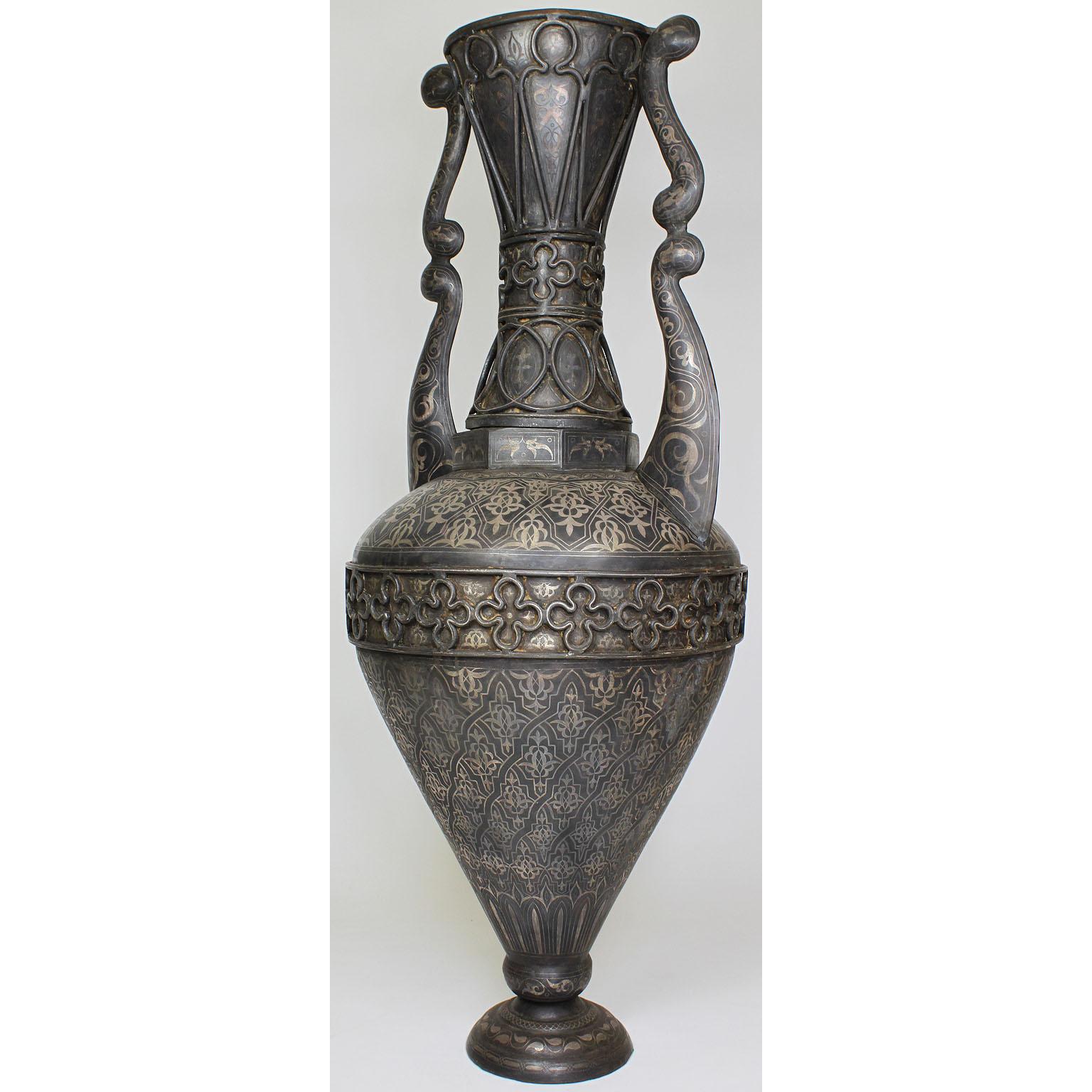 A large Spanish 19th century tooled metal overlaid vase in the style of Plácido Zuloaga (1834-1910). The tall baluster form in the Moorish or Islamic ovoid body vase decorated with arabesque roundels and cartouches against a ground of swirling