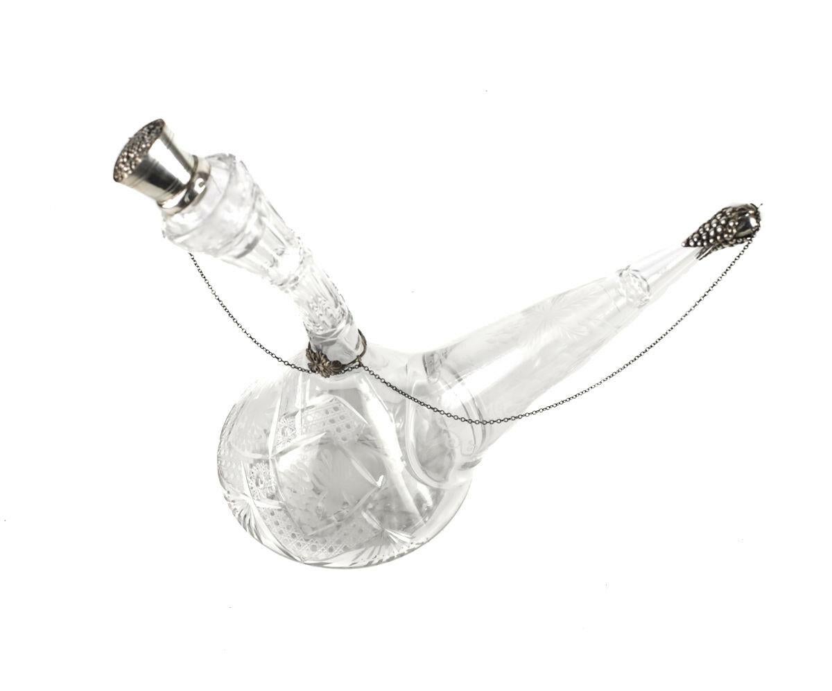 Spanish .915 Silver & Crystal Wine Decanter w Sterling Silver Overlay Stopper

Spout cover and chain - sterling overlay stopper features barrel with grapes, spout topper is in the form of grapes and leaves. Held with ring and chain. Hallmarks on