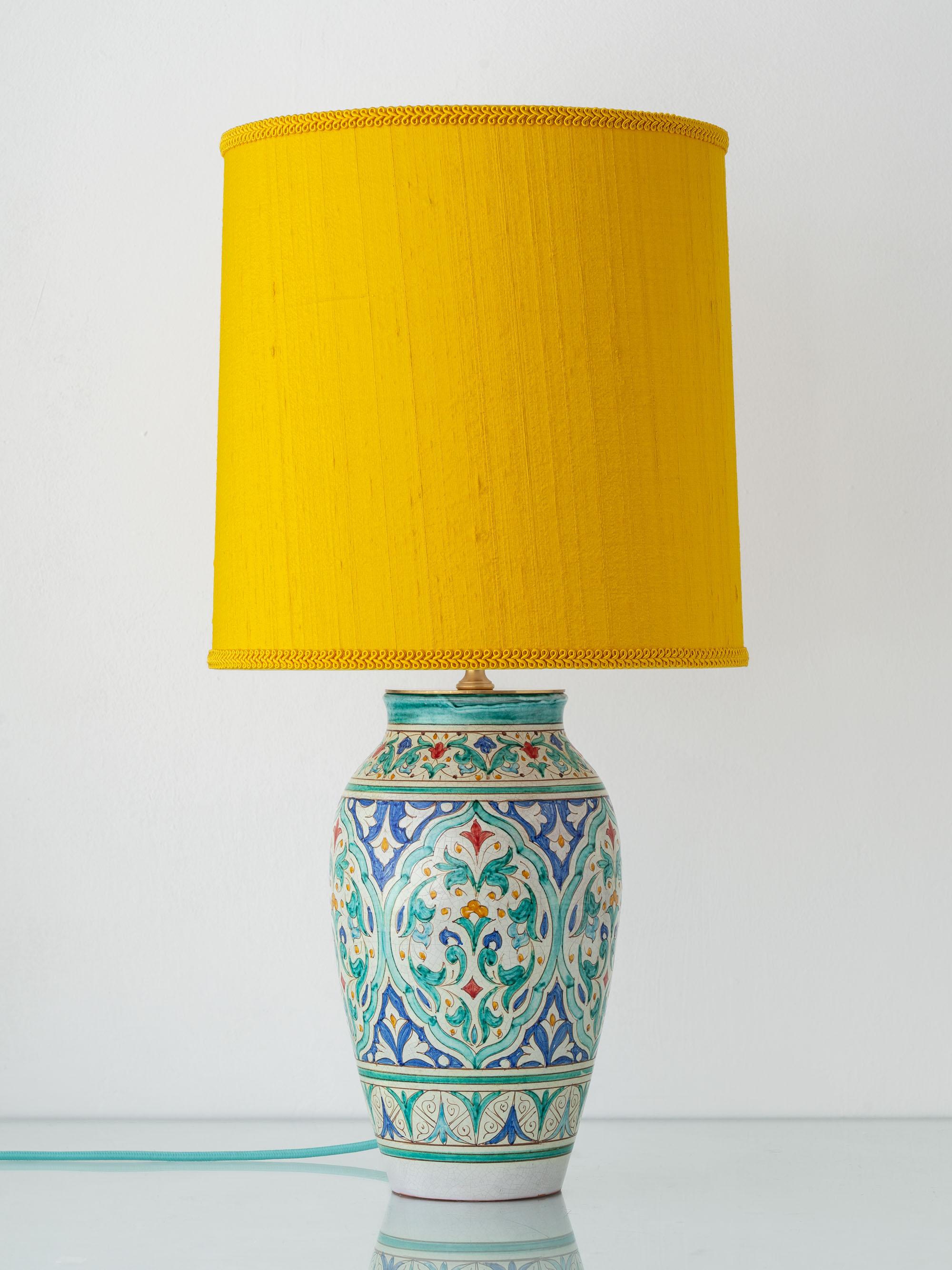 Lovingly hand-crafted by Amitābha Studio from a Spanish hand-painted Nasrid ceramic vase by Al Yarrar of Granada, this Andalusian ceramic table lamp embodies the luminous artistry of southern Spain. The vase base showcases intricate Moorish geometry
