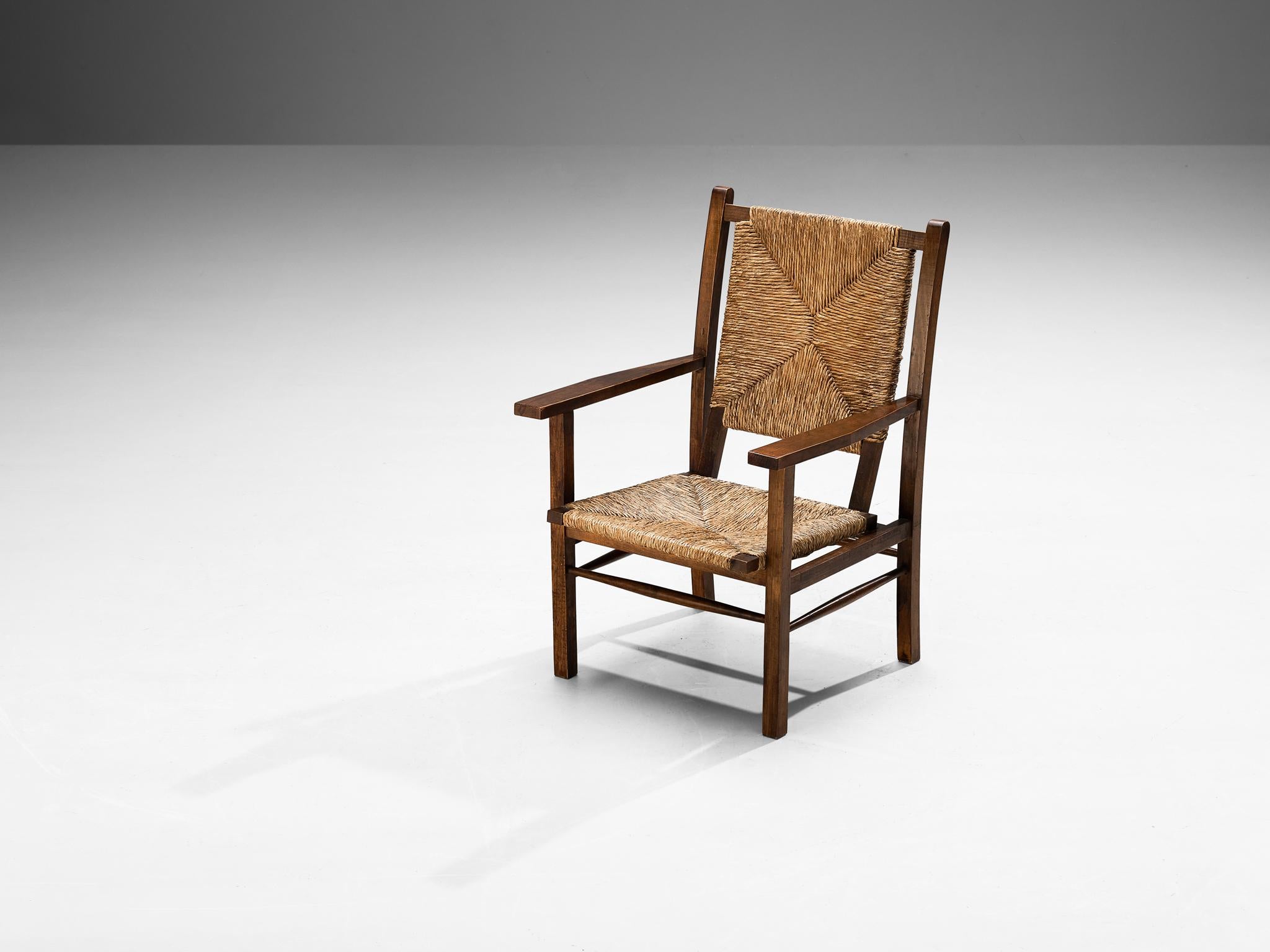 Armchair, stained pine, straw, Spain, 1960s

This beautifully constructed lounge chair embraces an evolved pastoral character with great quality of elegance. The wooden frame features a solid, open construction of straight lines and round corners.
