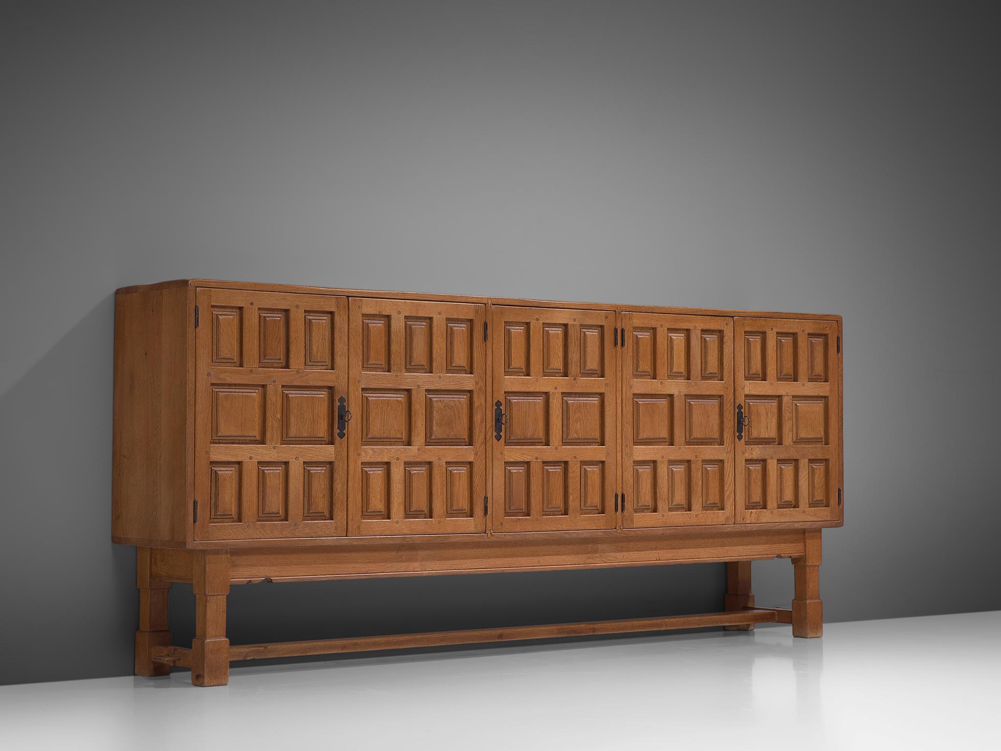 Sideboard, oak and iron, Spain, 1930s

Stunning Art Deco sideboard with geometric carving in the wooden doors. This five door cabinet is executed in wood with a nice patina. Plenty of storage space goes behind the doors, with several shelves and