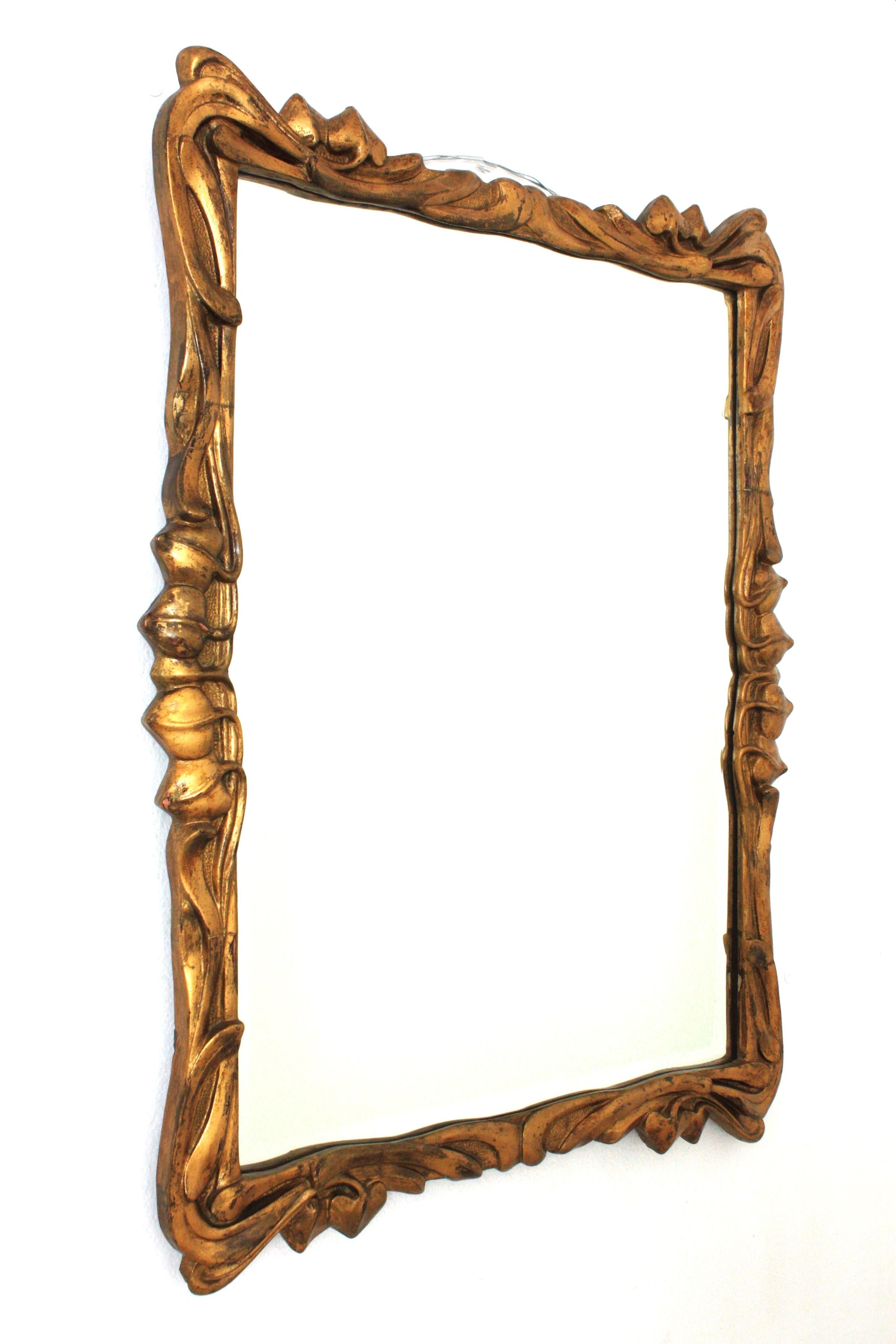 Art Nouveau Rectangular Mirror with Foliage Frame, Wood, Gold Leaf

Outstanding finely carved wood Art Nouveau mirror. Spain, 1930s
Carved wood and gold leaf gilding.
The frame has finely carved branches and leaf details thorough. Eye-catching