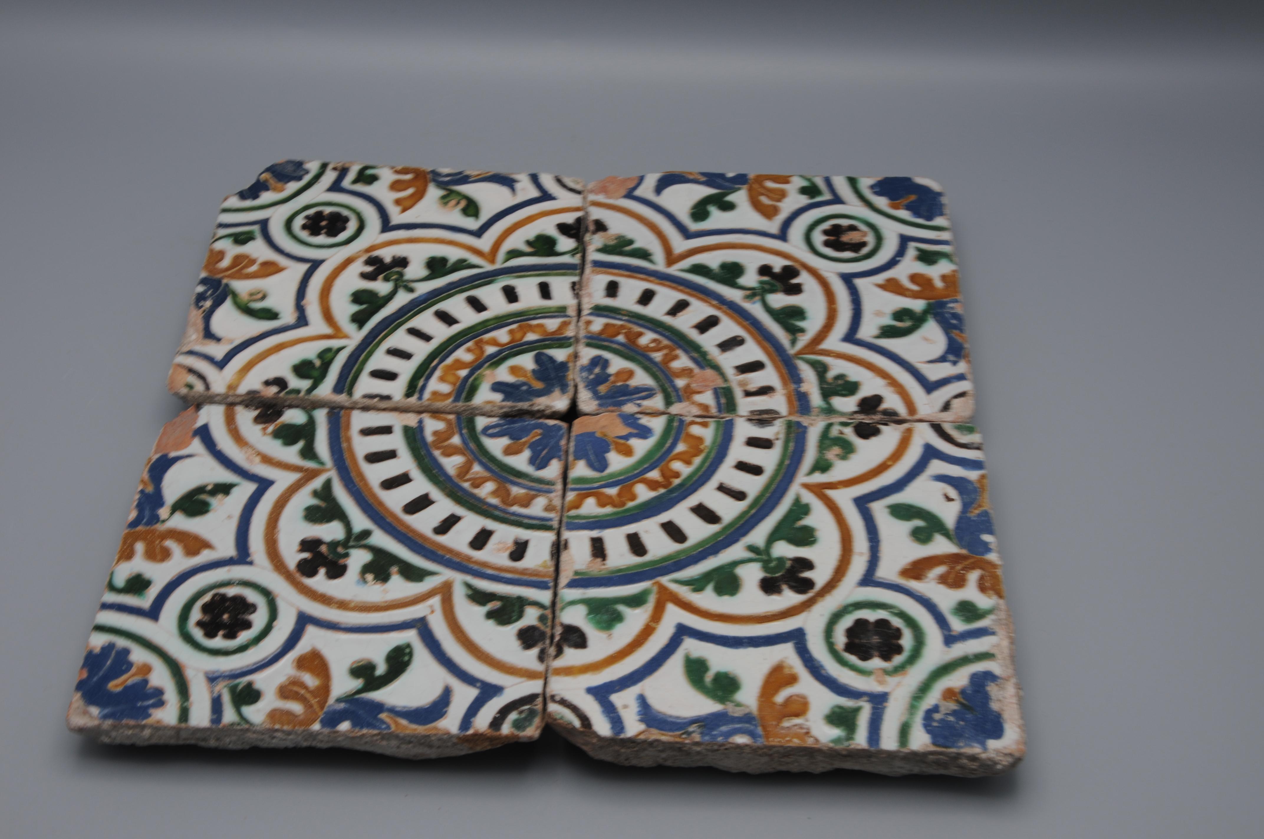 A set of four early Arista y Cuenca tiles from Toledo, Spain, dating to circa 1550–1575. These tiles were produced during the Spanish Renaissance, a period when Toledo was a major center for ceramic production. The tiles are decorated with stylized