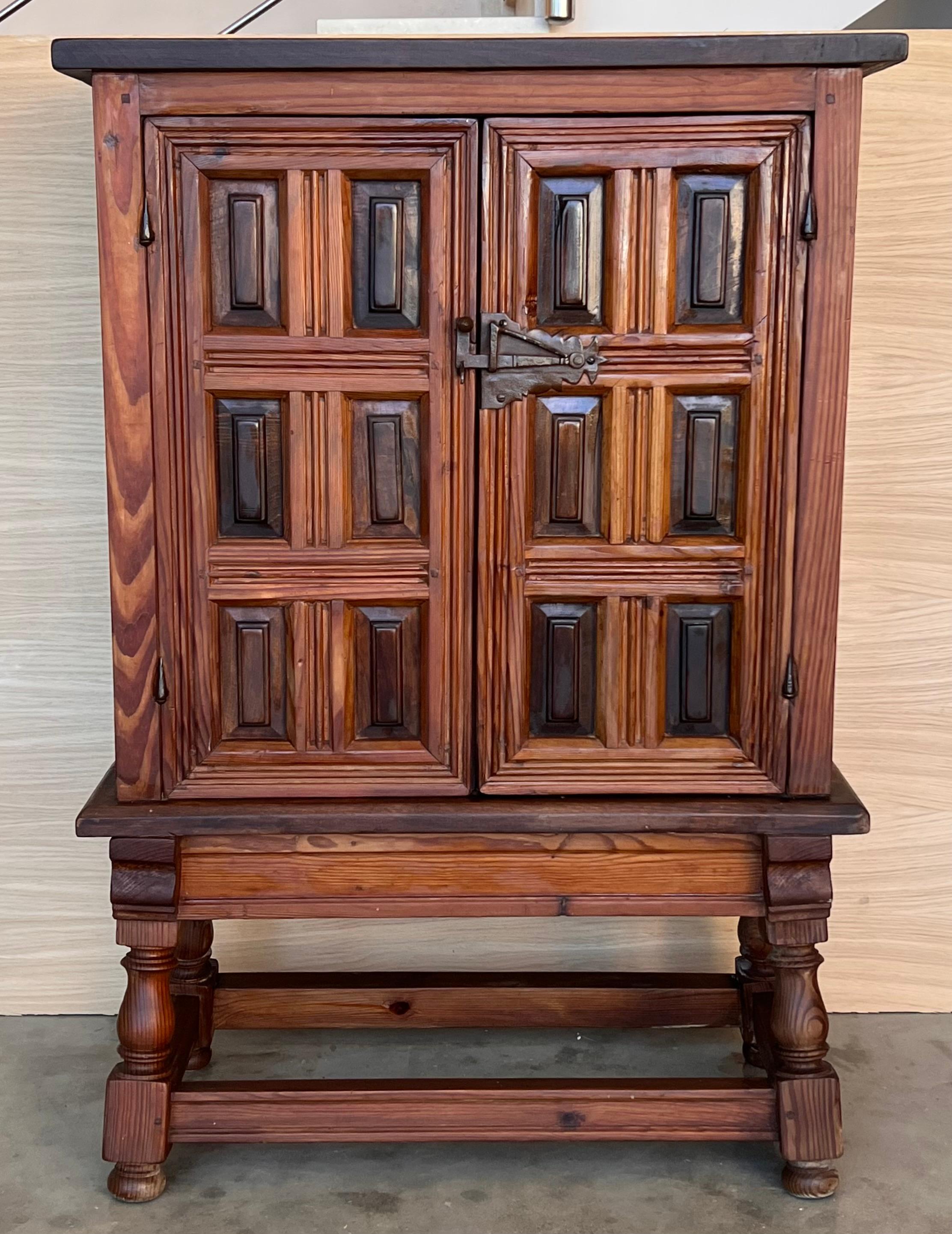 19th Catalan Spanish Baroque carved walnut Tuscan two door cabinet.

From the north of Spain, built in solid walnut, the rectangular top with a molded edge on a box that fits into two solid walnut paneled doors with one shelve inside and raised on