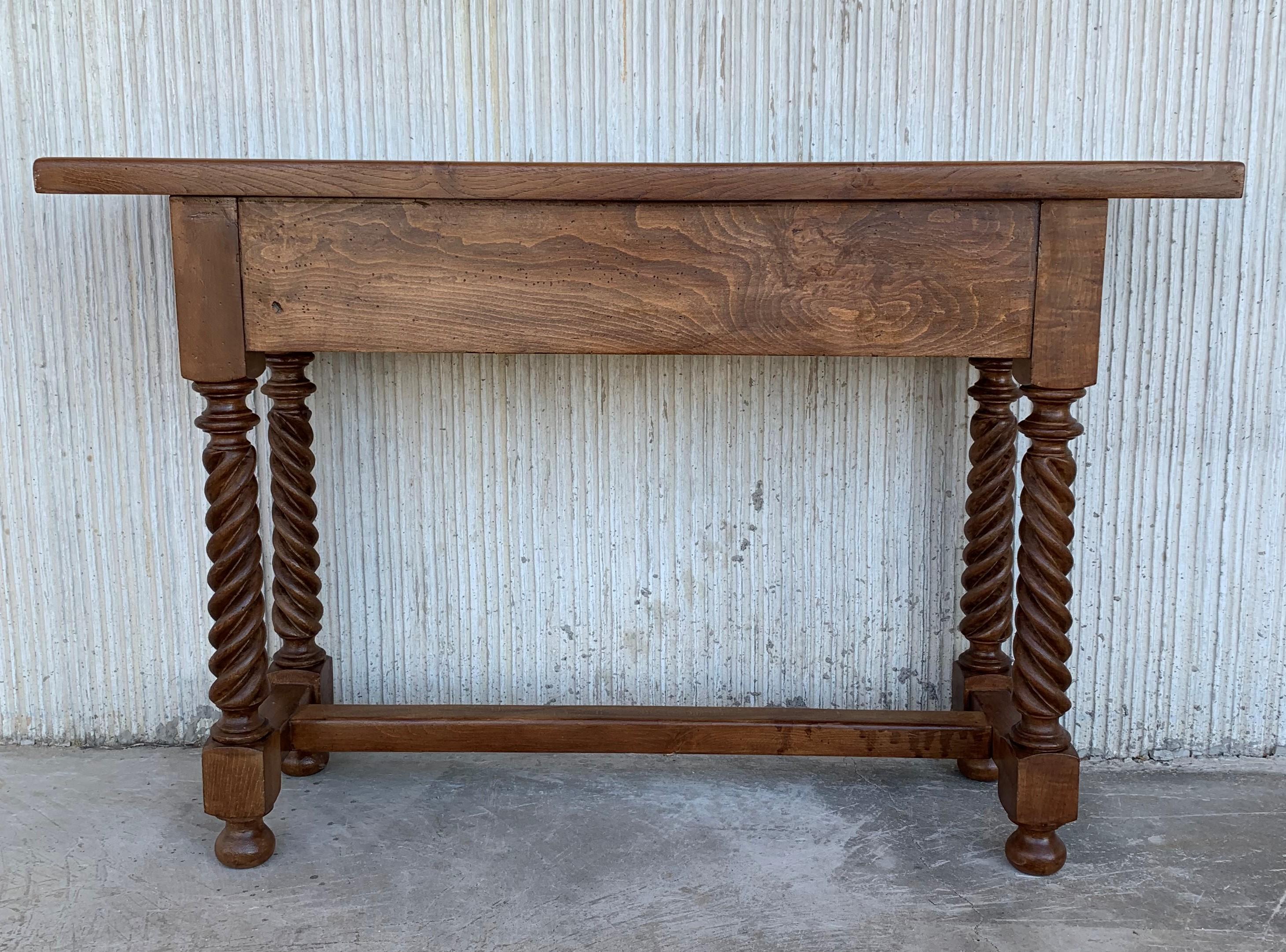 Spanish Baroque carved walnut console table with two drawers, circa 1860.
A 19th century walnut console table with a slab top above a frieze with two drawers with front decorated with carved geometrical motifs and incised with additional decoration